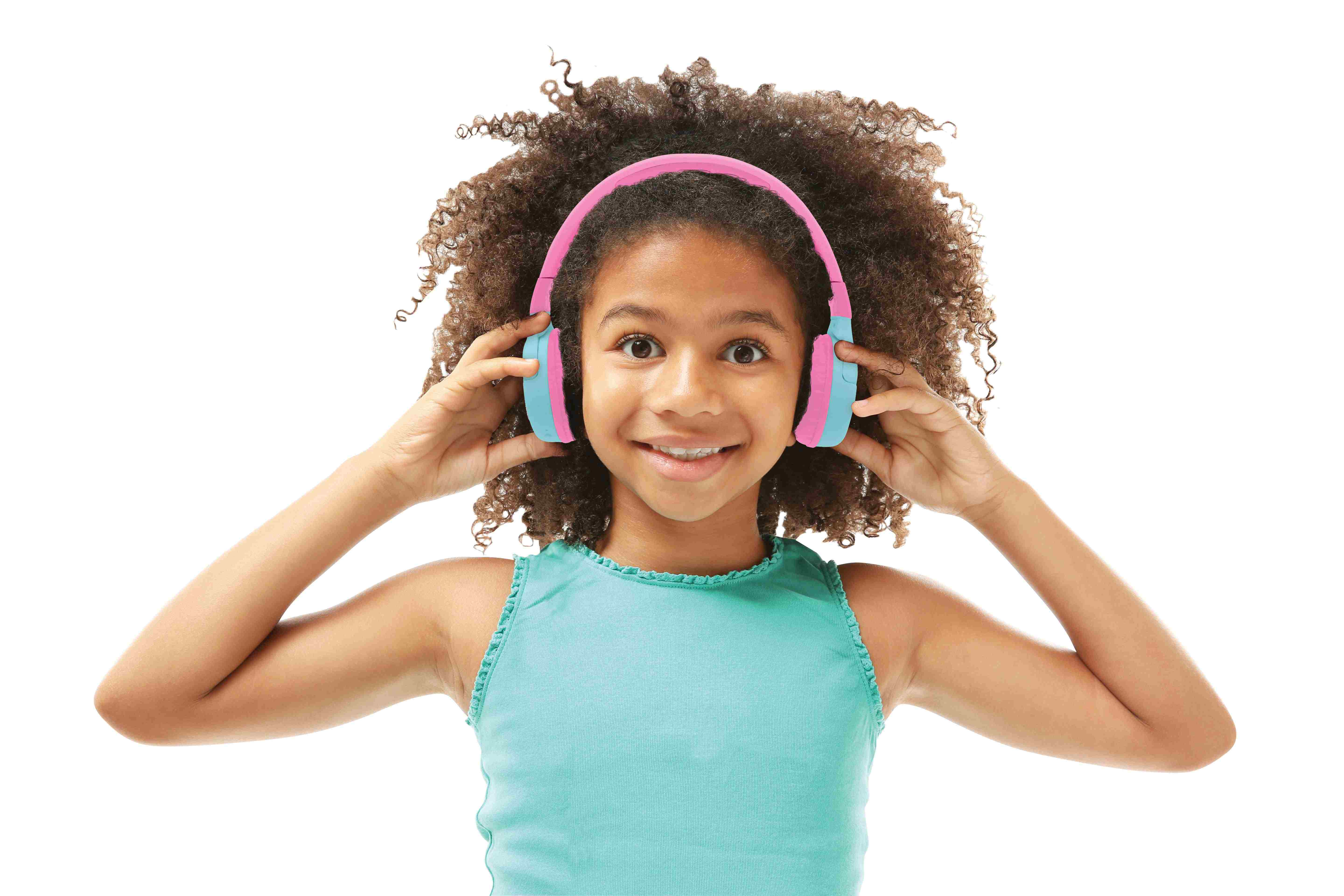 Niña con cabello rizado usando auriculares rosas y azules sonríe a la cámara.