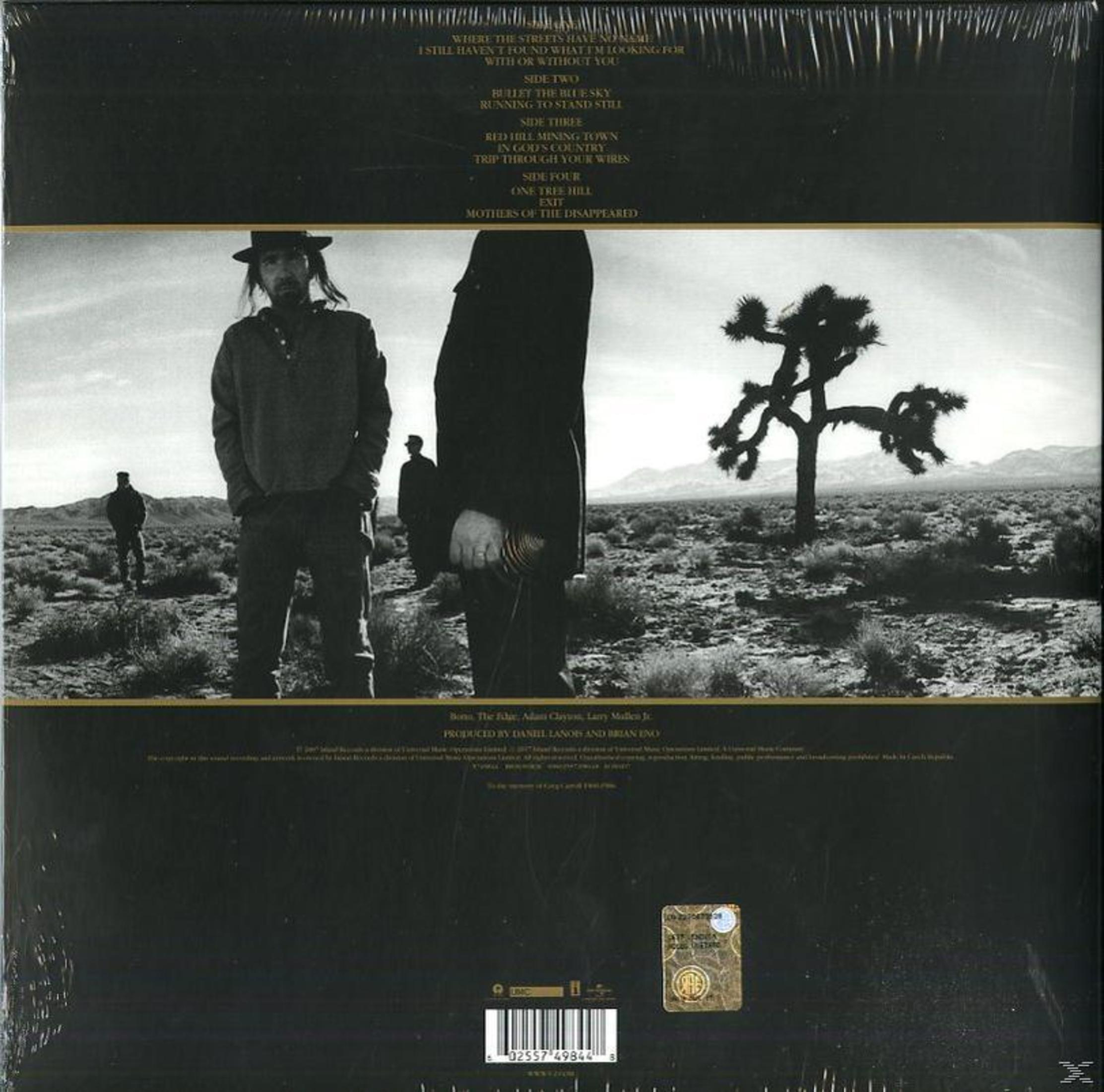 Album cover with a band standing in the desert. Text on the back: 'U2 - The Joshua Tree'.