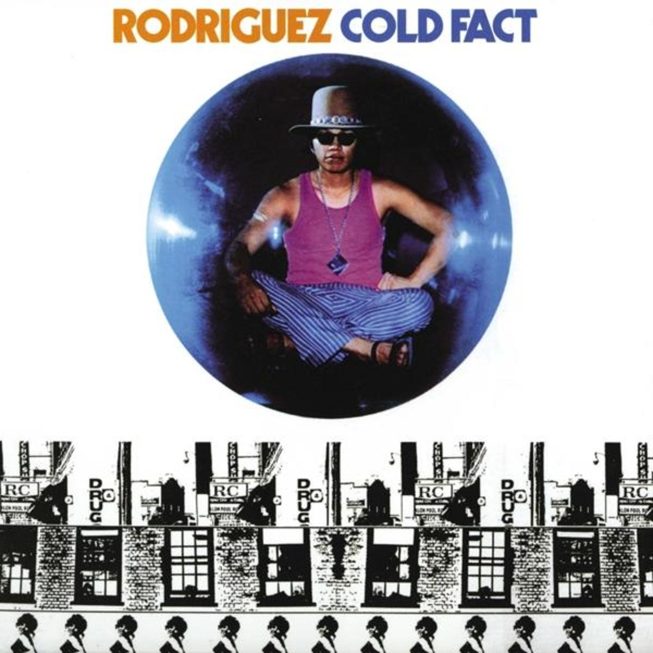 La copertina dell'album mostra un uomo in una bolla blu, con cappello e occhiali da sole, sopra edifici in mattoni.