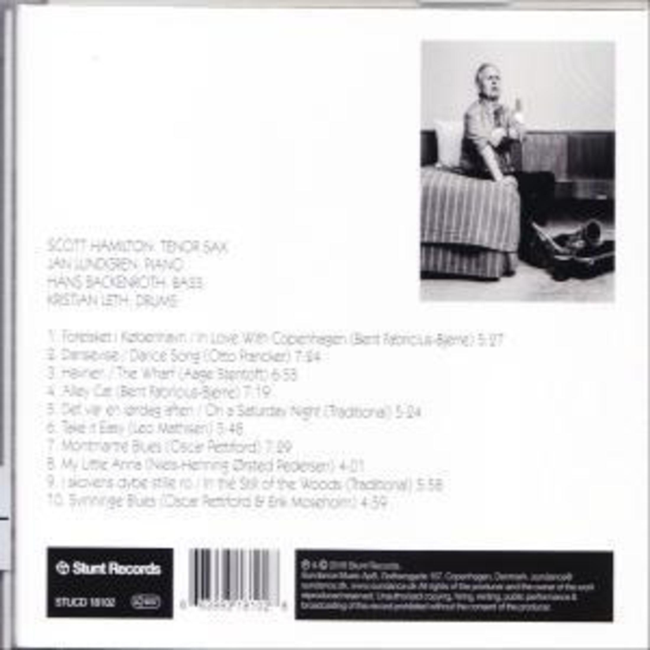 Album cover: A man in a suit sitting down, with text and a record label.