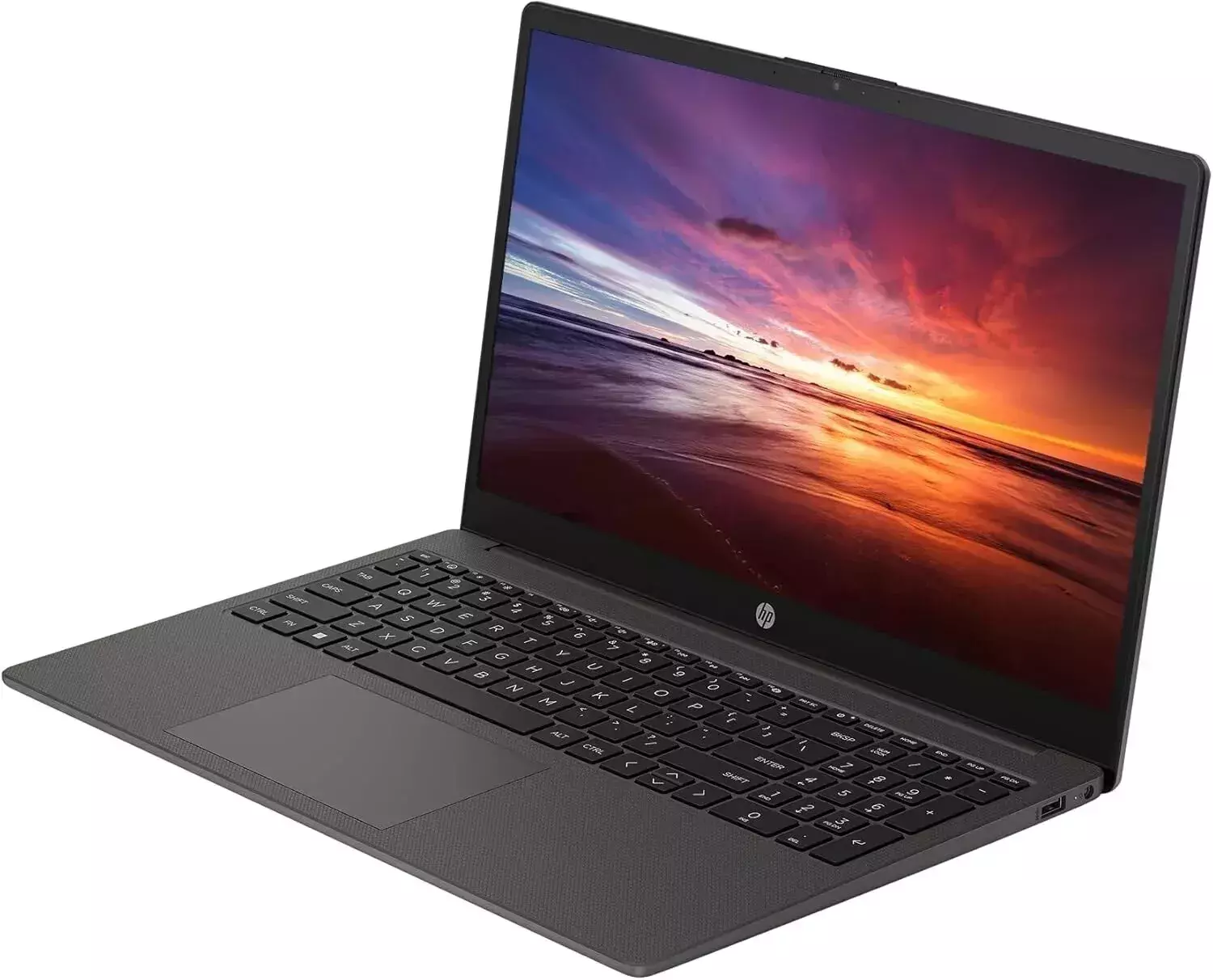 Laptop auf Weiß. Bildschirm zeigt Sonnenuntergang über Strand. Dunkelgrauer Körper.