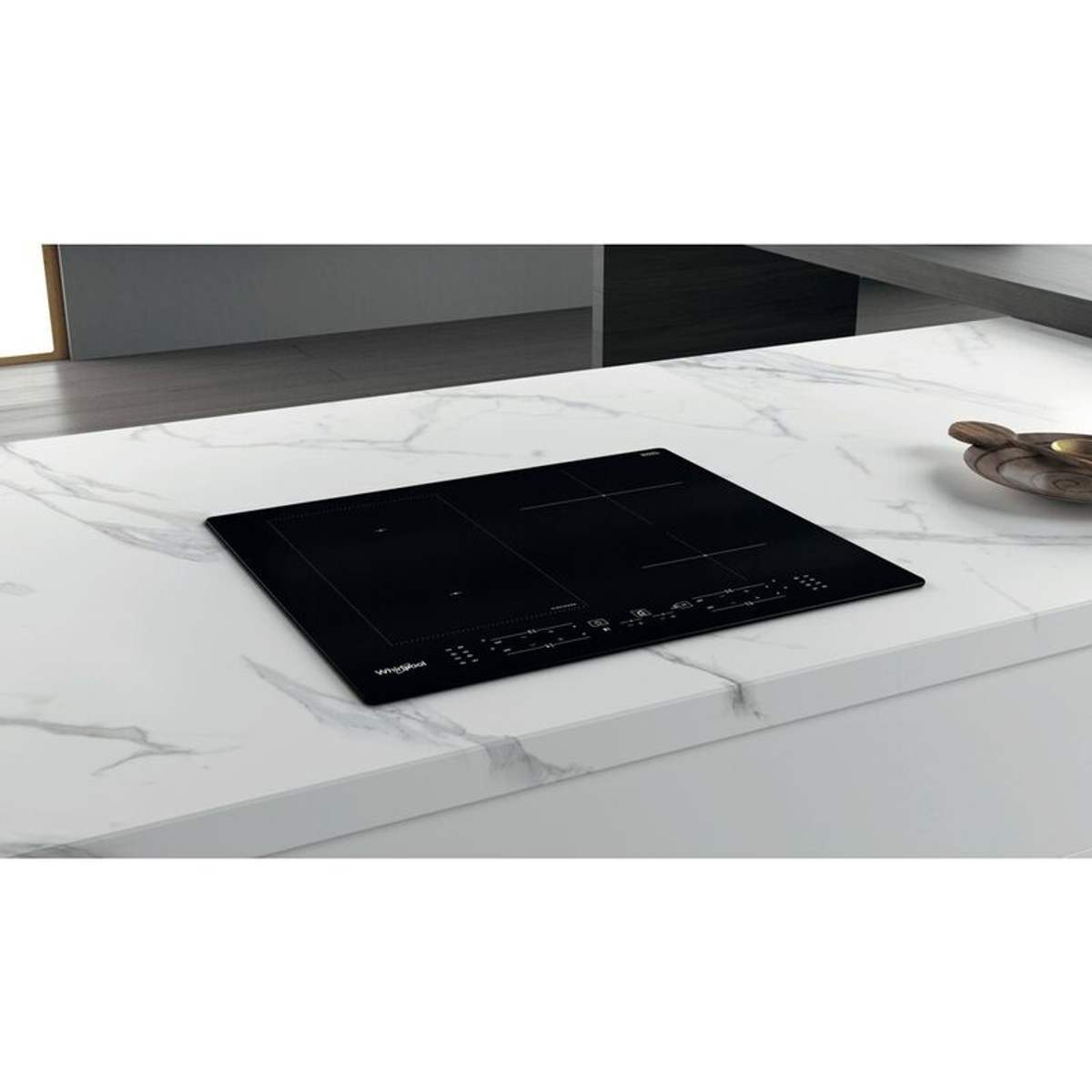 Placa de inducción negra sobre una encimera de mármol blanco. La placa tiene dos zonas de cocción y controles.