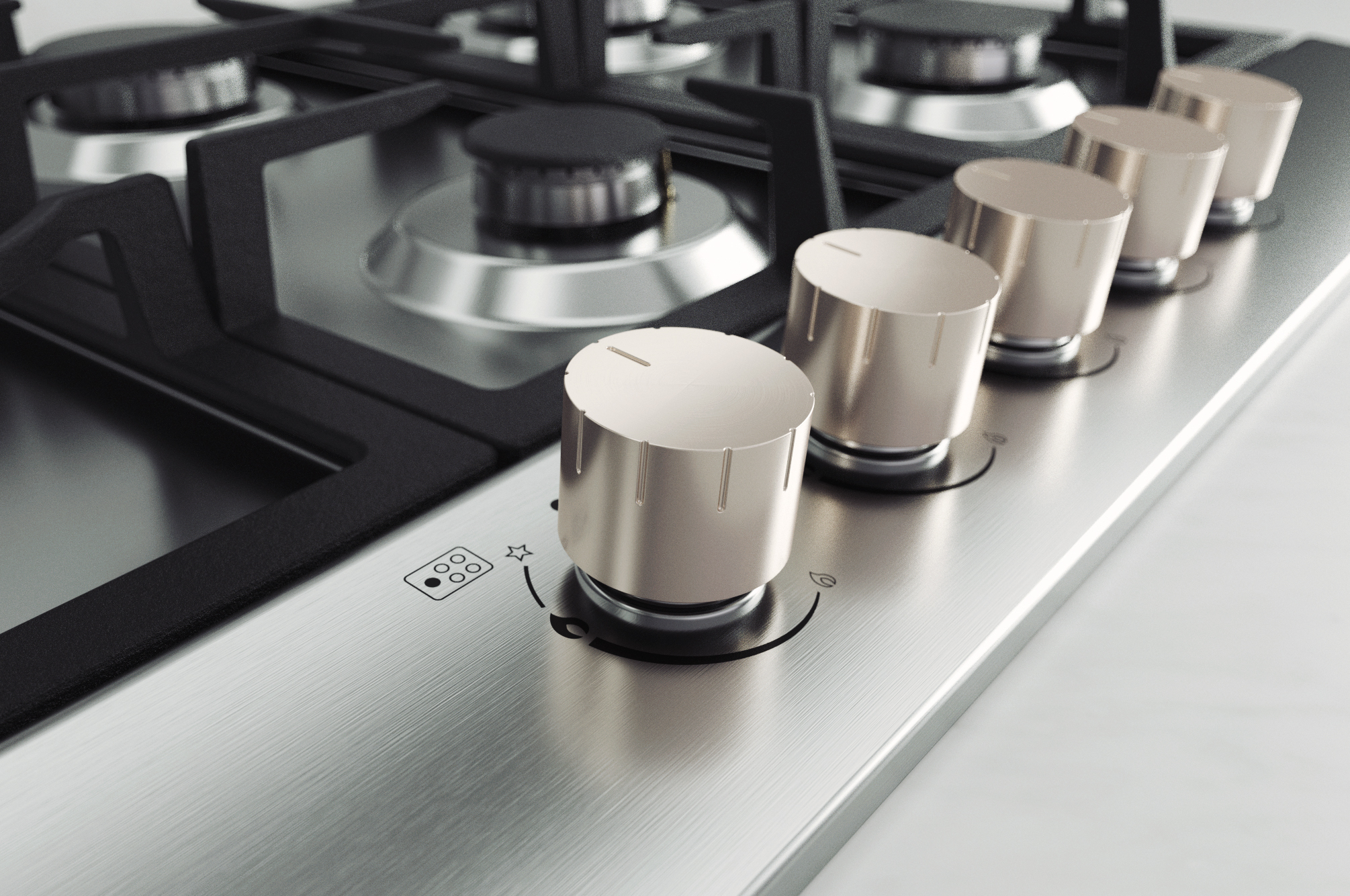 Zbliżenie kuchenki gazowej. Widoczne srebrne pokrętła i palniki. Metalowa powierzchnia.