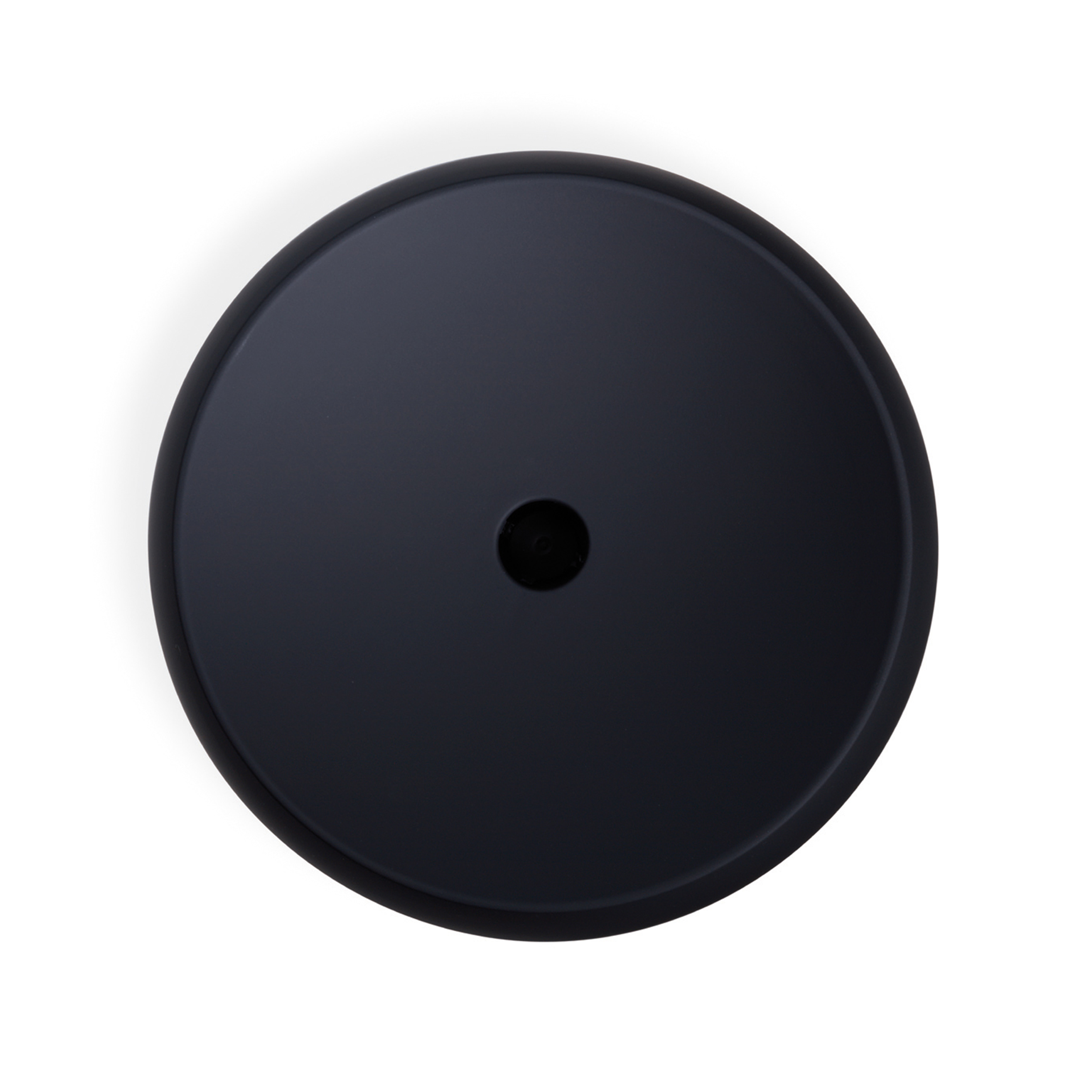 Black, round object with a small central hole, seen from above.