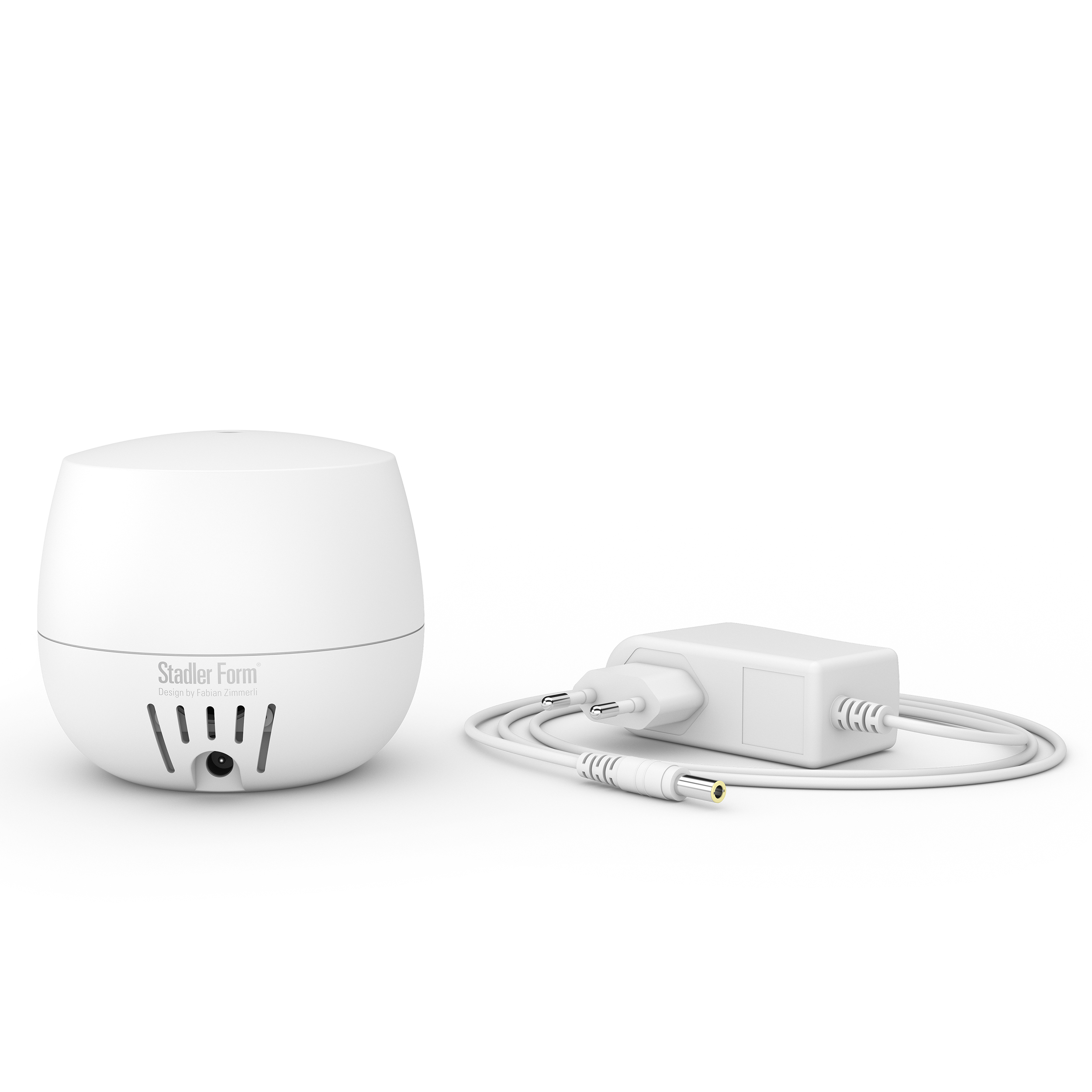 White essential oil diffuser with power adapter and cable. Stadler Form brand.