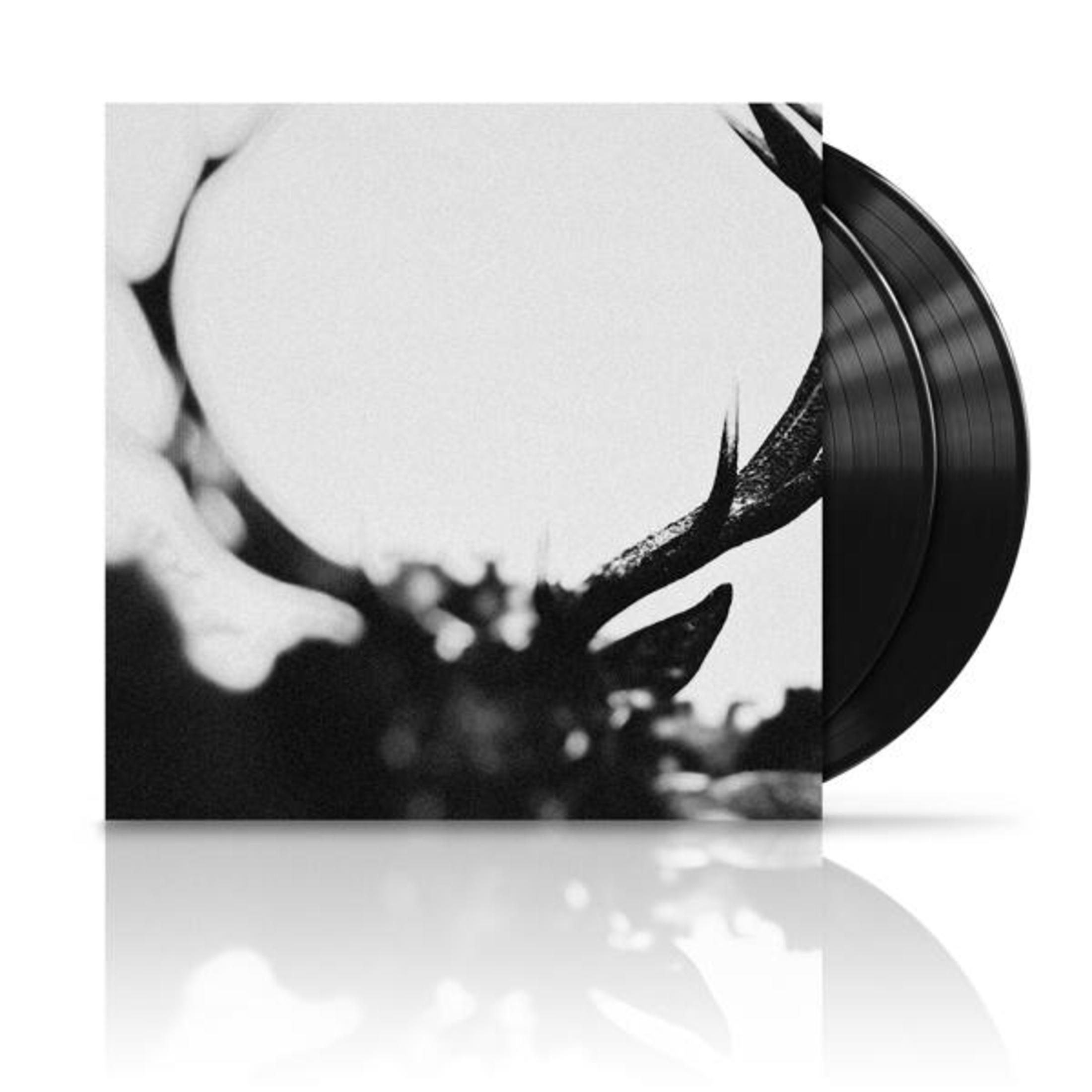 Copertina dell'album in bianco e nero con forme astratte. Due vinili neri a destra.