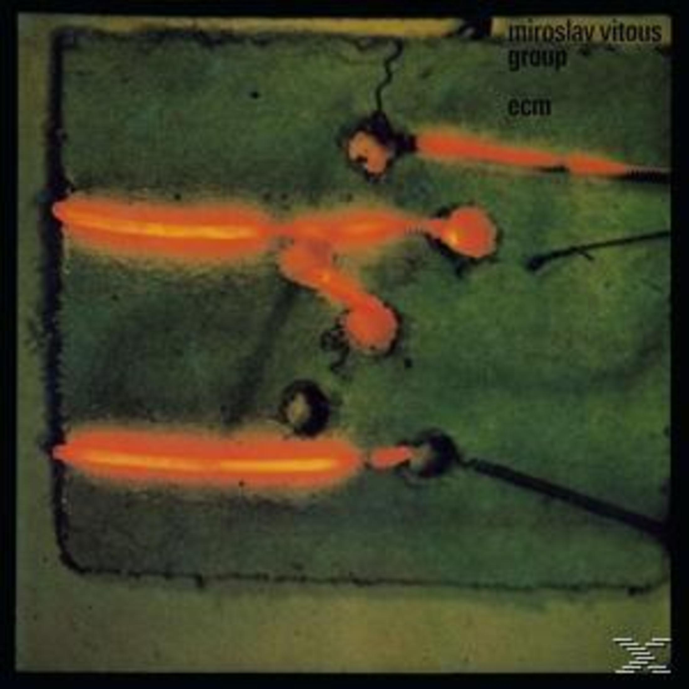 Pochette d'album avec des formes orange incandescentes sur fond vert. Cadre noir.
