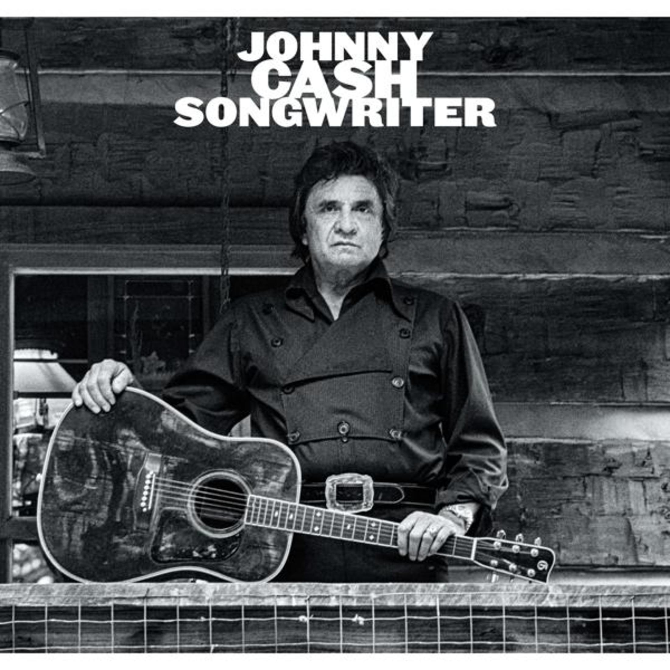 Pochette de l'album : Johnny Cash, Songwriter. Johnny Cash tenant une guitare, devant un fond en bois.