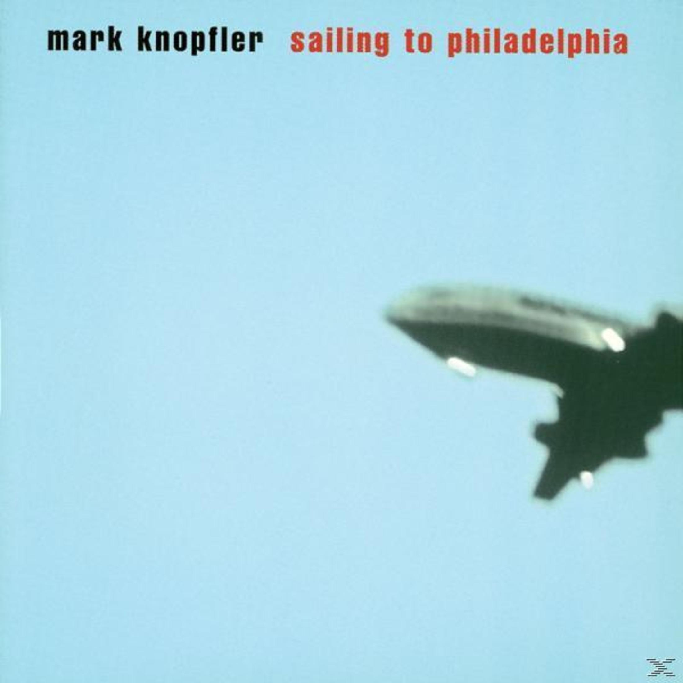 Albumcover: Mark Knopfler's 'Sailing to Philadelphia'. Vliegtuig in blauwe lucht, tekst bovenaan.