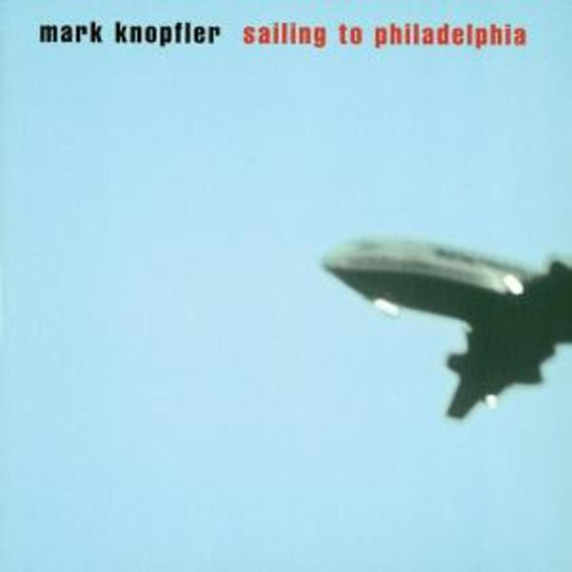 Albumhoes: 'Mark Knopfler Sailing to Philadelphia'. Vliegtuig vliegt tegen een blauwe lucht.