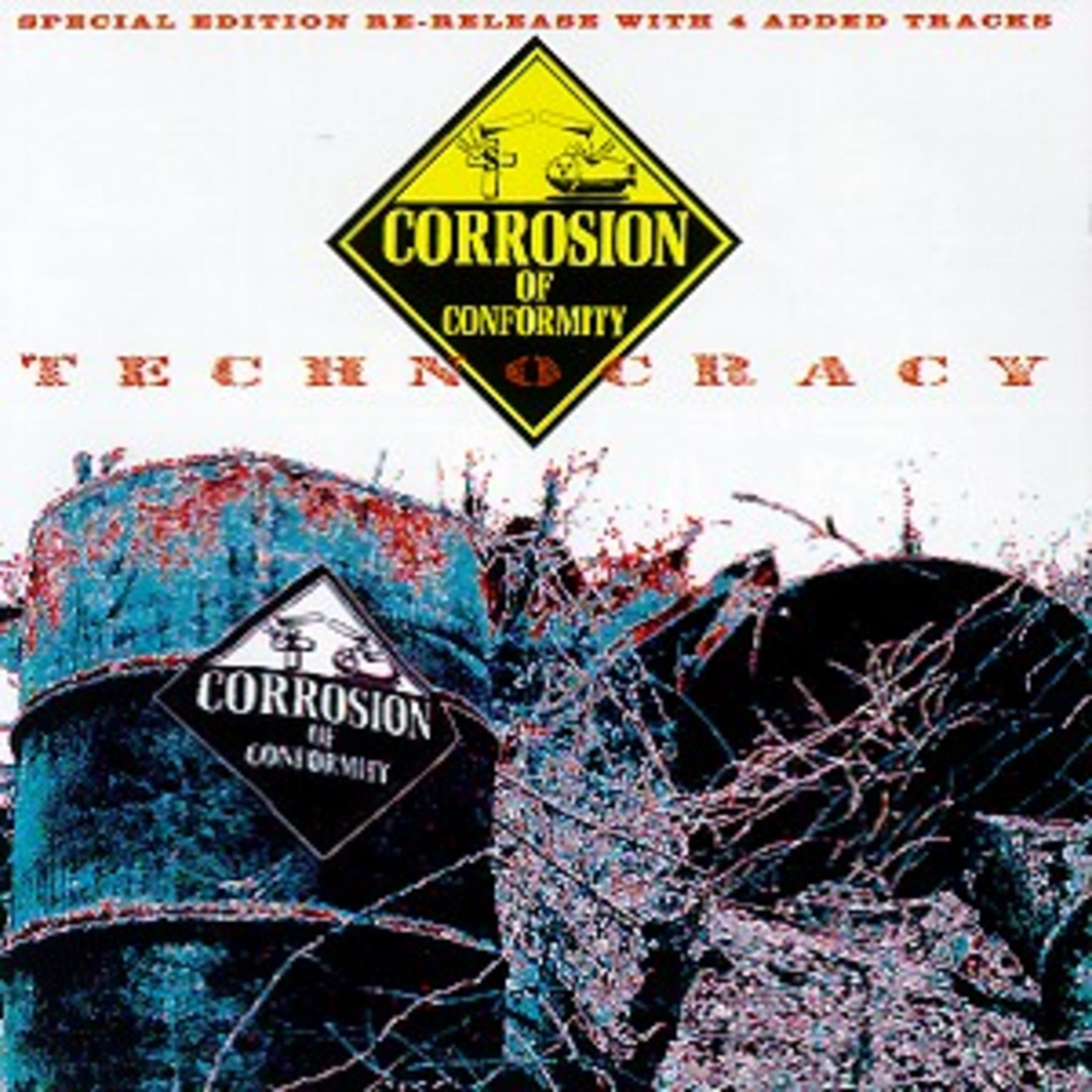 Albumhoes met roestige vaten en een waarschuwingsbord. De tekst luidt "Corrosion of Conformity".