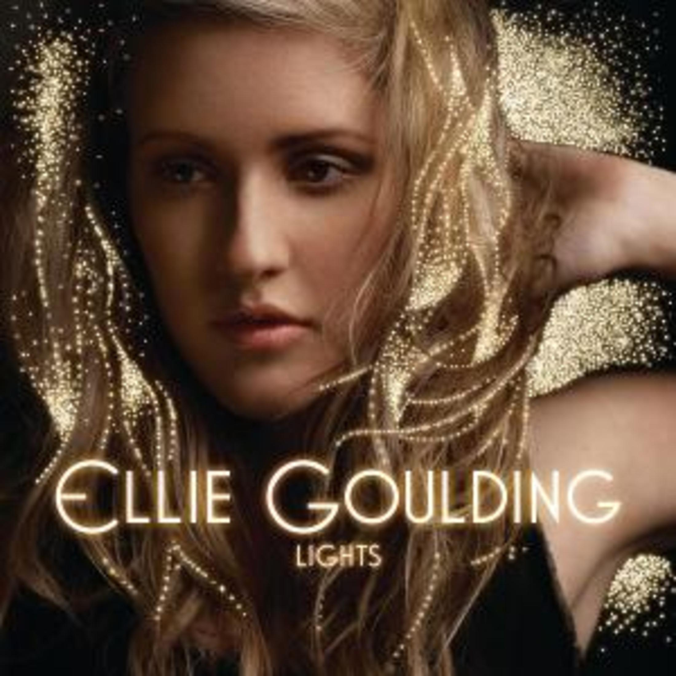 Albumhoes van Ellie Goulding met haar gezicht, gloeiende lichten en de albumnaam.
