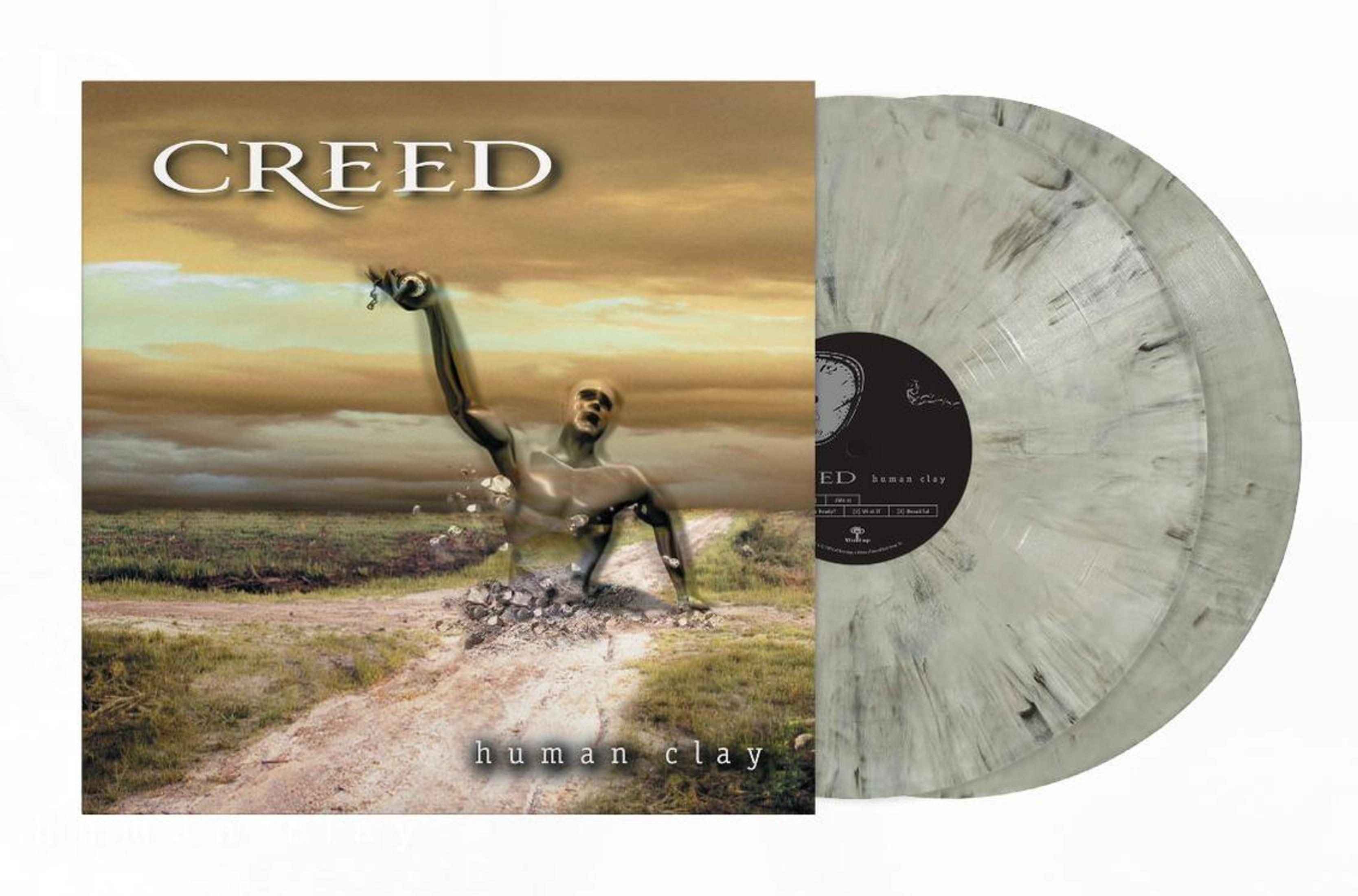 Portada del álbum: Un hombre que emerge del suelo, con el cuerpo roto, en una carretera desierta. Dos discos de vinilo.
