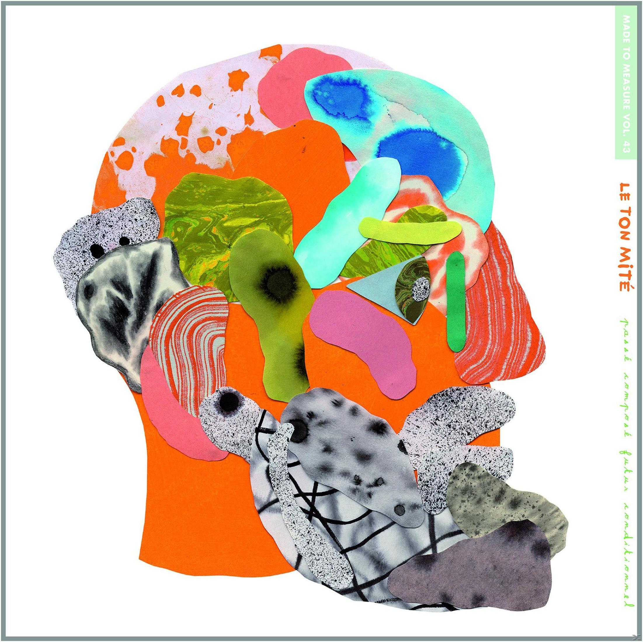 Œuvre d'art abstraite en forme de tête. Plusieurs couleurs. Texte : Le Ton Mité, Made to Measure.