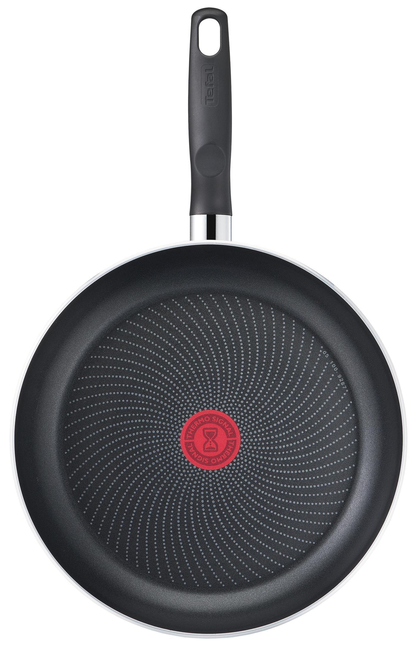 A black frying pan with a red circle in the center. The pan has a non-stick surface and a long handle.