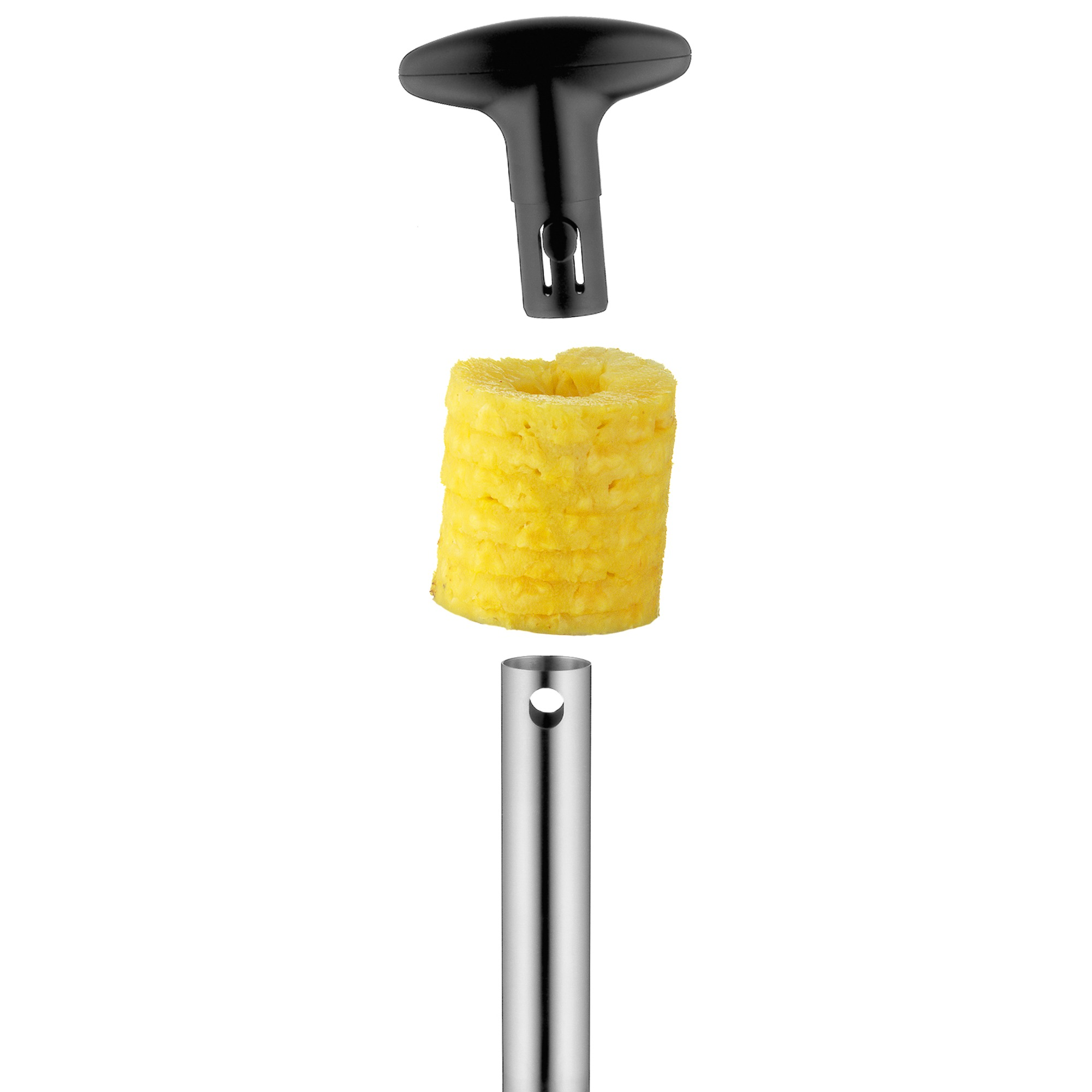 Narzędzie do wykrawania ananasa i ananas. Narzędzie jest metalowe i czarne. Ananas jest żółty.