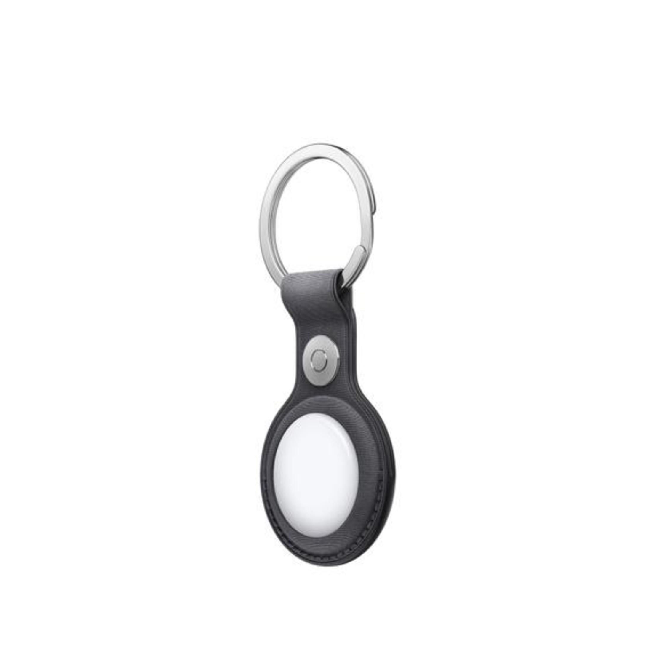 Black and grey Apple AirTag keychain. Silver ring and black leather. White circle in the center.