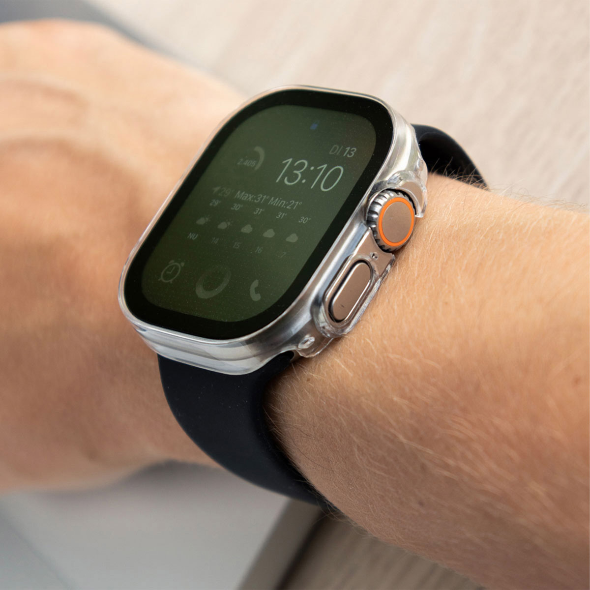 A person's wrist with a smartwatch. Watch face shows time and other data.