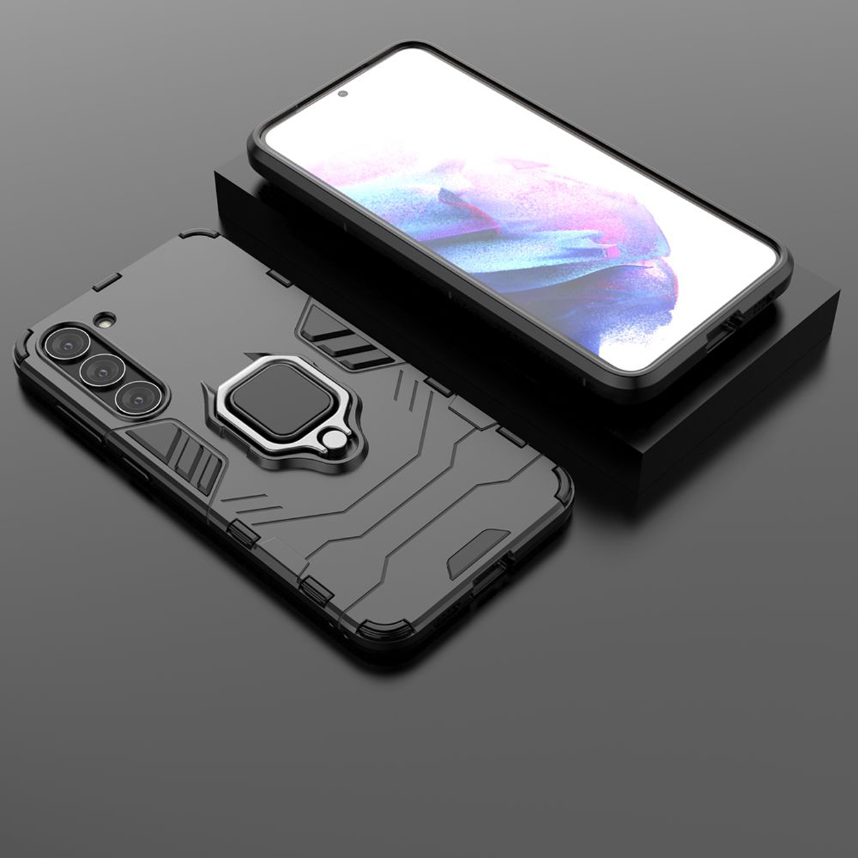 Een zwarte telefoon met hoesje, met ringstandaard, staat naast een telefoon op een standaard. Zwarte achtergrond.