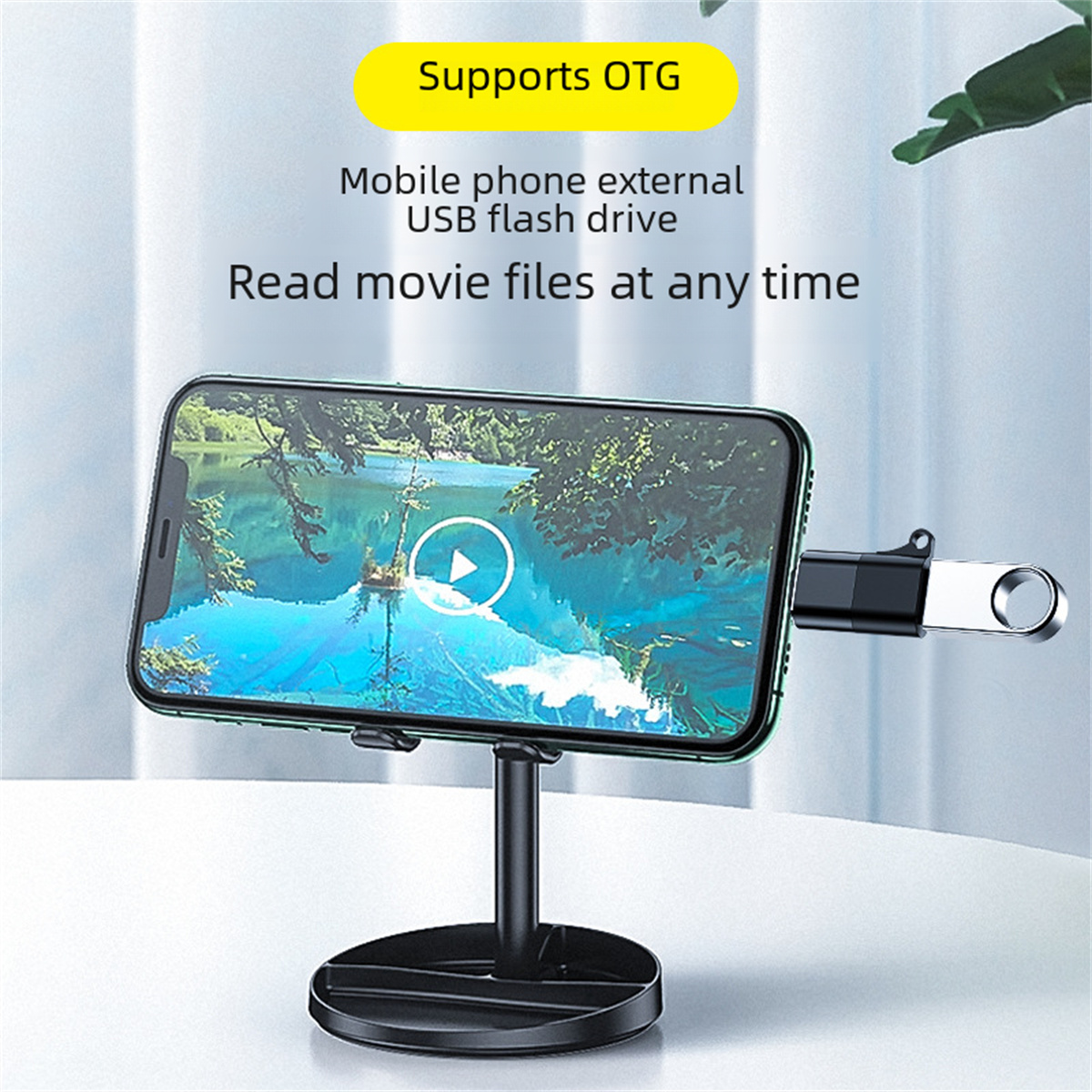 Ein Smartphone auf einem Ständer mit angeschlossenem USB-Stick, Text über OTG-Unterstützung.