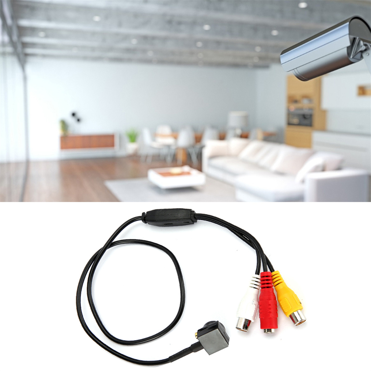 Eine kleine Überwachungskamera und ein Kabel mit Cinch-Anschlüssen, drinnen, mit verschwommenem Hintergrund.