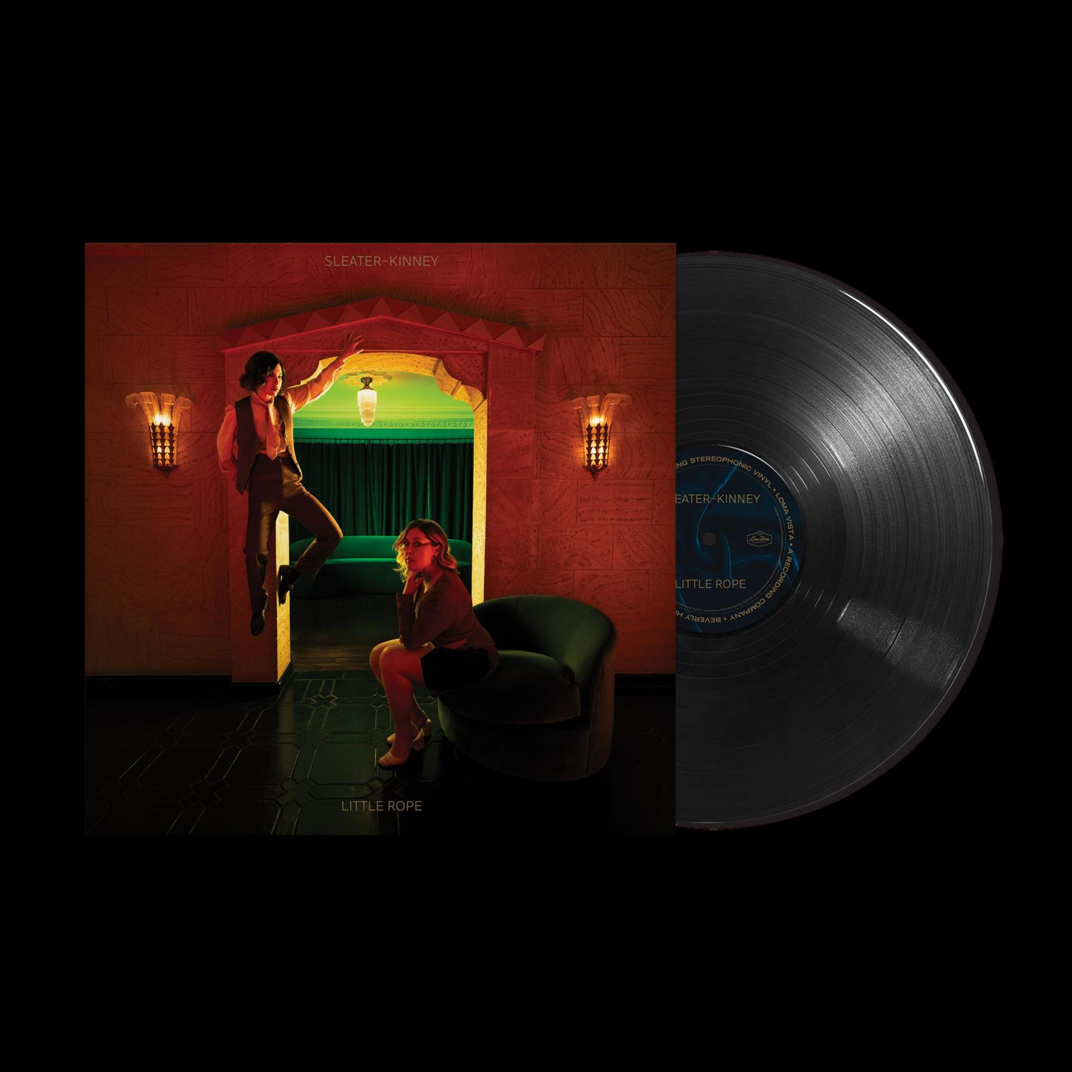 Album cover: Sleater-Kinney. Two women in a room, with a record on the right.