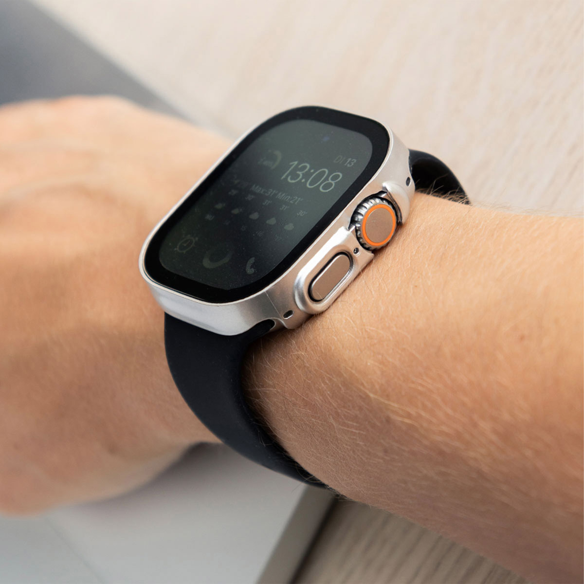 A wrist wearing a smartwatch, showing the time and other data on the screen.