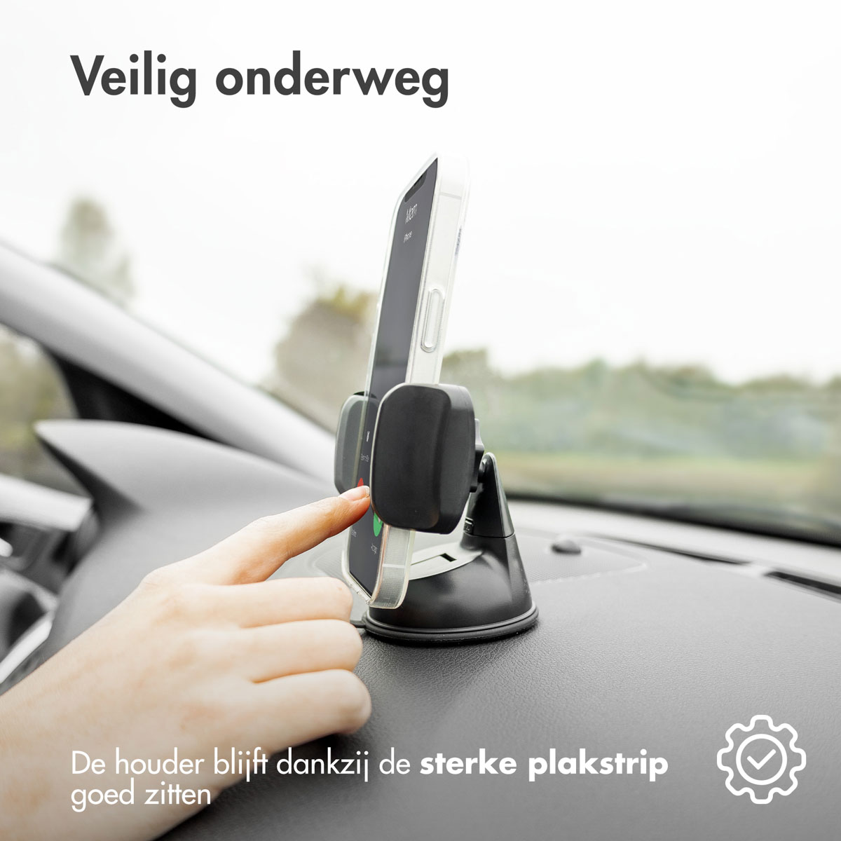 Hand pointing to phone in car holder, dashboard background, suction cup base, safe driving concept.
