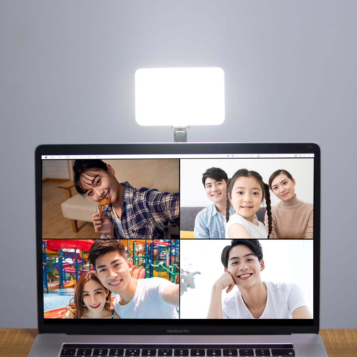 Laptop-Bildschirm zeigt Videoanruf mit vier Personen unter hellem rechteckigen Licht.