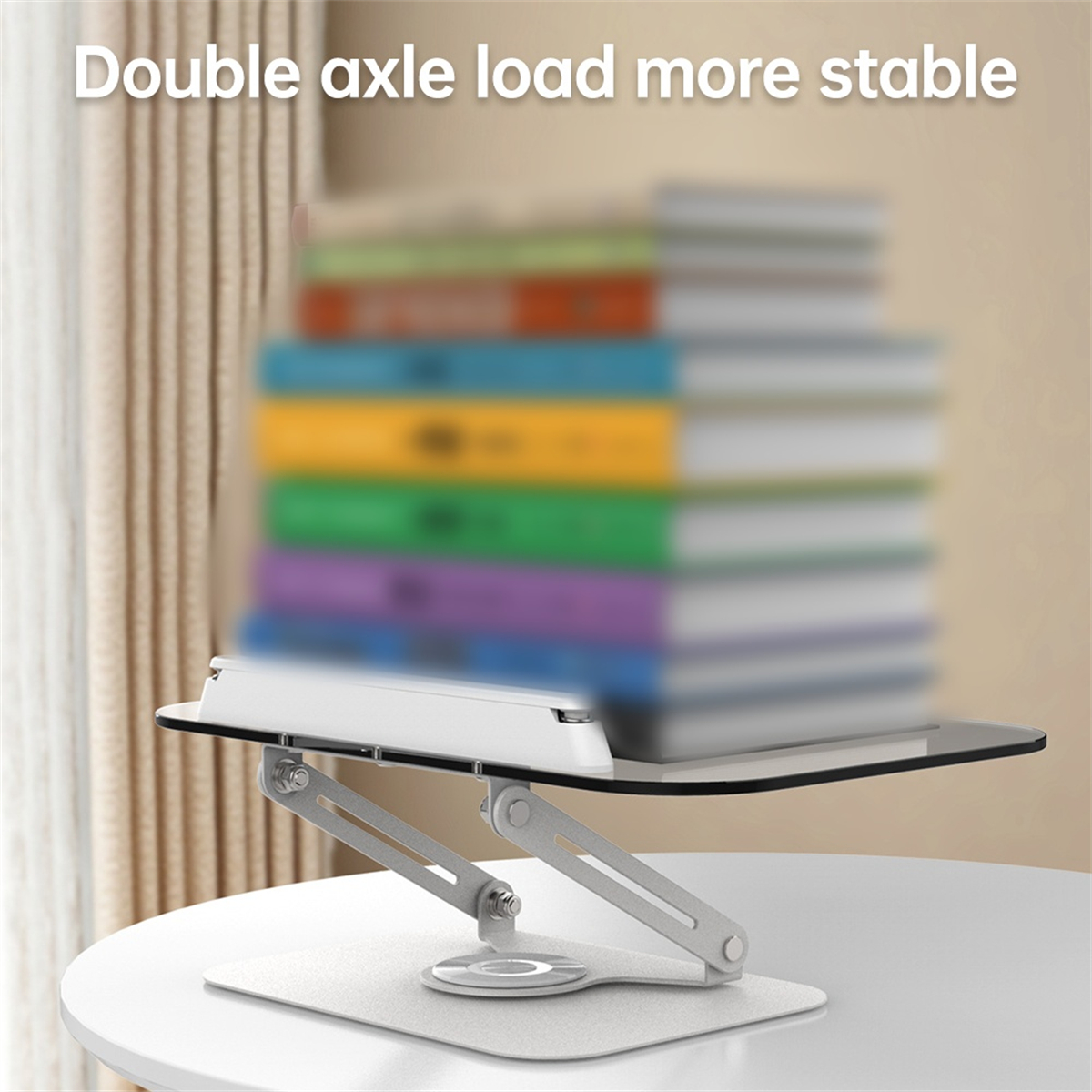 Ein Laptop-Ständer mit einem Tablet obenauf, das einen Stapel Bücher trägt, mit dem Text "Double axle load more stable".