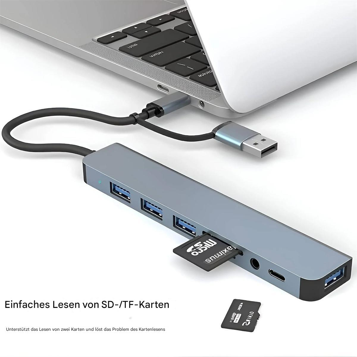 Silberner Hub, an einen Laptop angeschlossen. Es hat Anschlüsse, einen Kartenleser und ein schwarzes Kabel.