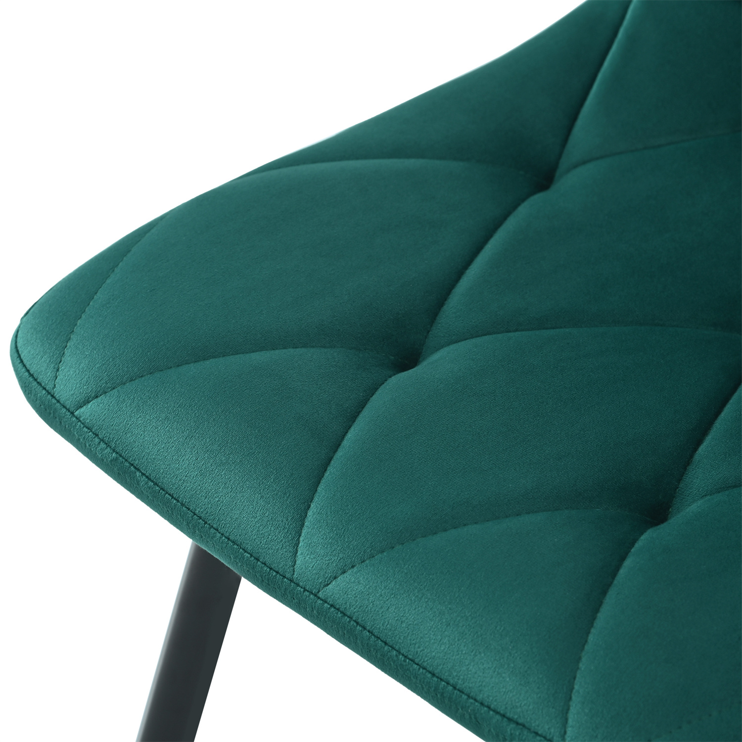 Nahaufnahme eines teal getufteten Stuhls. Der Stoff ist strukturiert und hat ein geometrisches Muster.