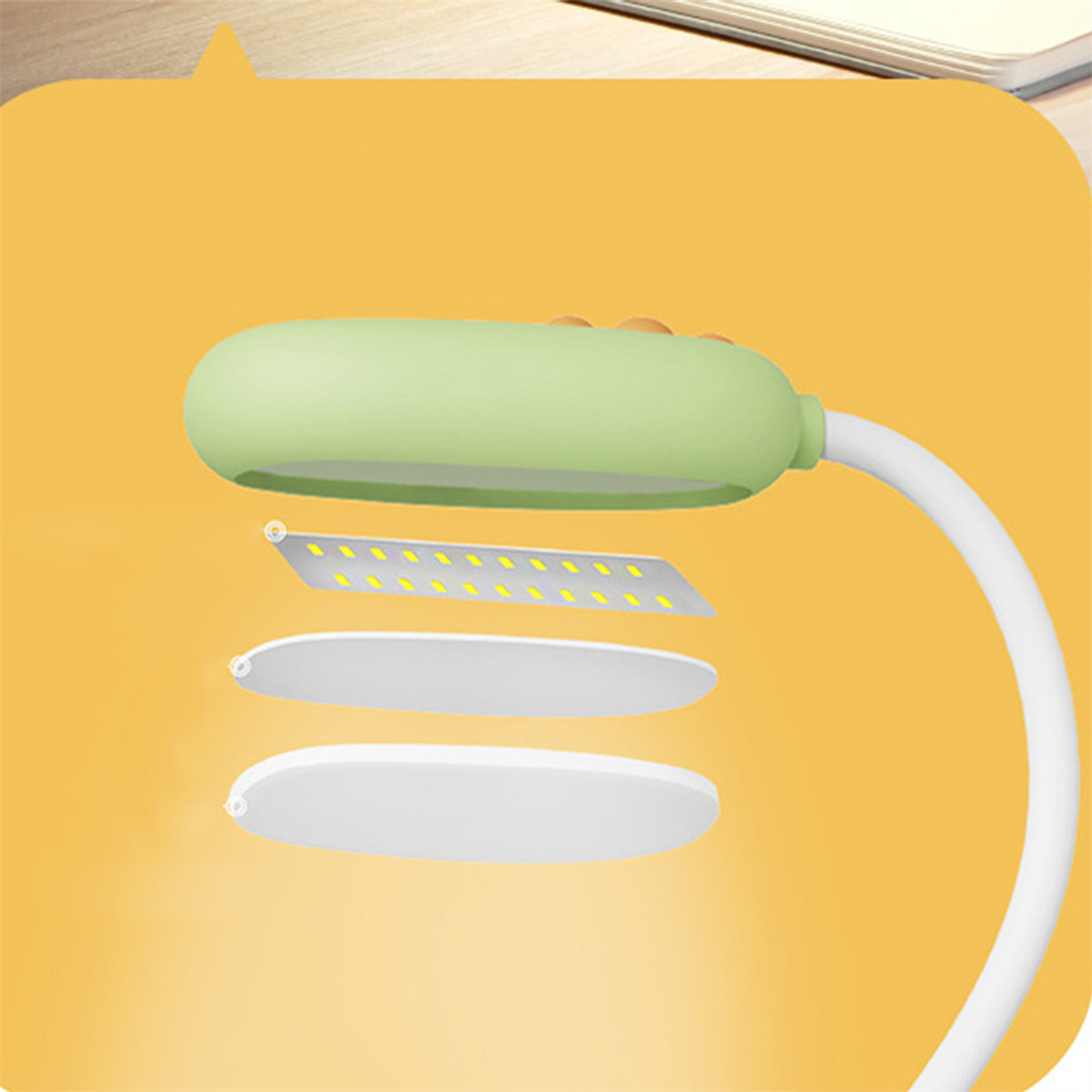 Grüne Lampe mit flexiblem Hals. Details der inneren Komponenten sind sichtbar. Weißer Hintergrund.