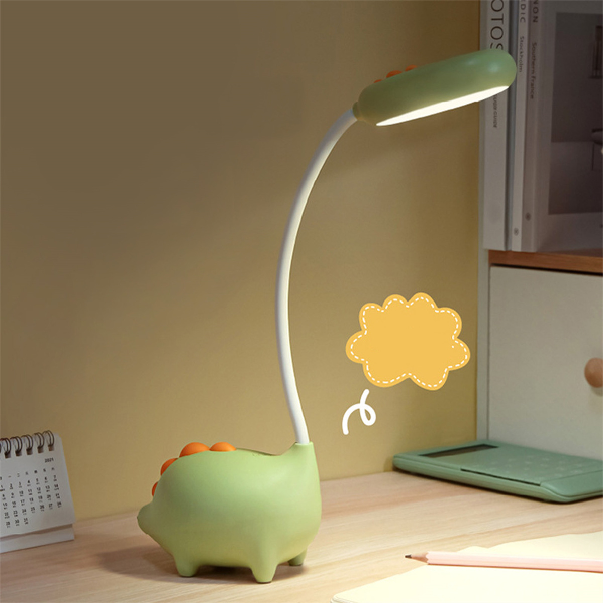 Grüne Dinosaurierlampe mit Licht. Eine gelbe Sprechblase ist daneben.