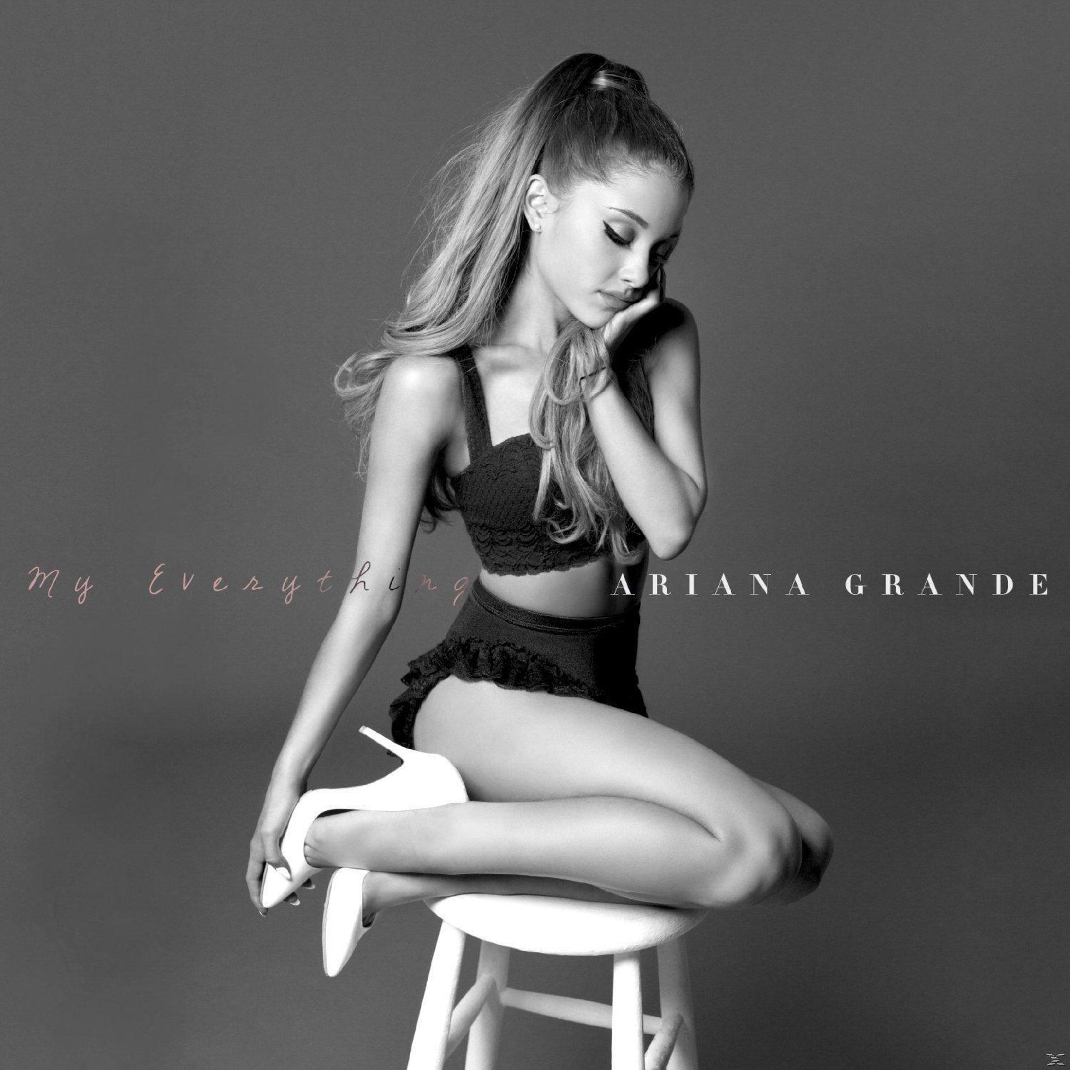 Ariana Grande album cover. She's in black lingerie, sitting on a stool, hand on her face, in black and white.