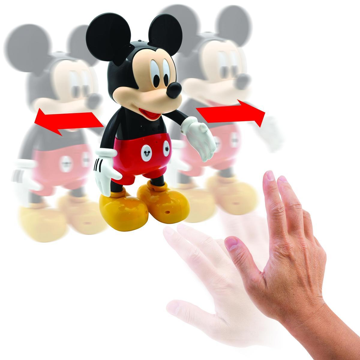 Giocattolo di Topolino in movimento con una mano tesa, frecce che indicano la direzione.