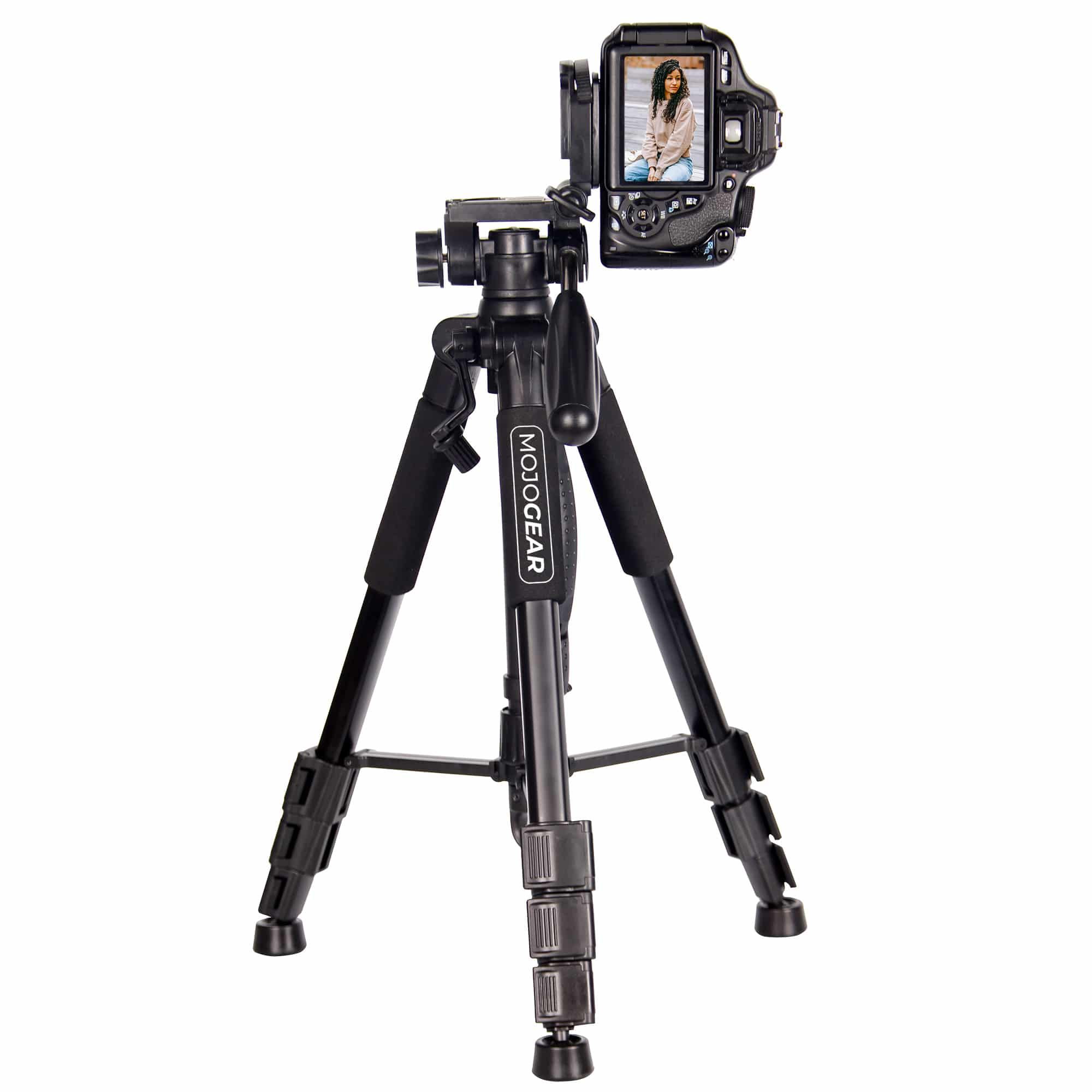 Camera on black tripod. The camera shows a woman. Tripod is on white surface.