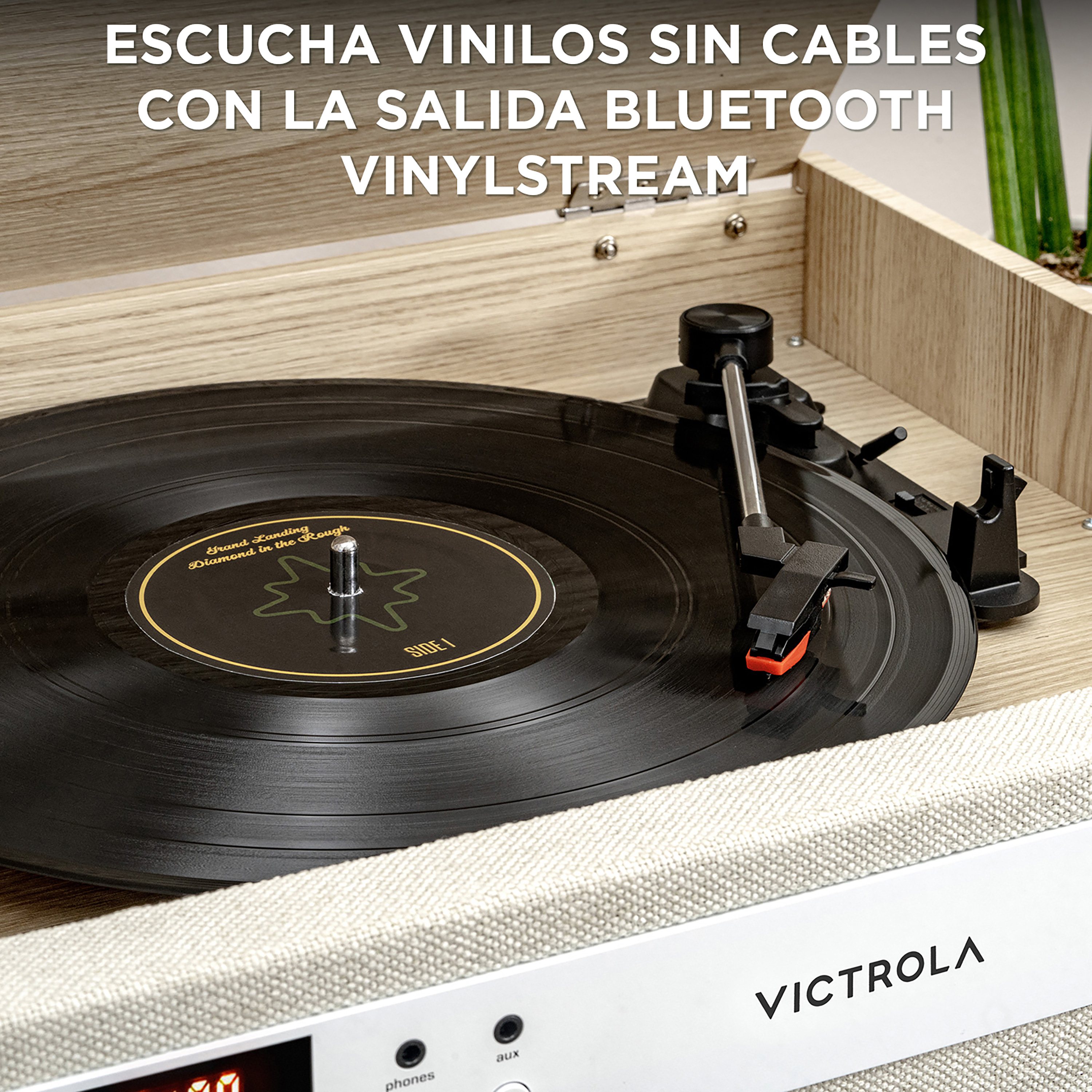 Un giradischi con un disco in vinile nero. Testo in spagnolo: Ascolta vinili senza cavi.