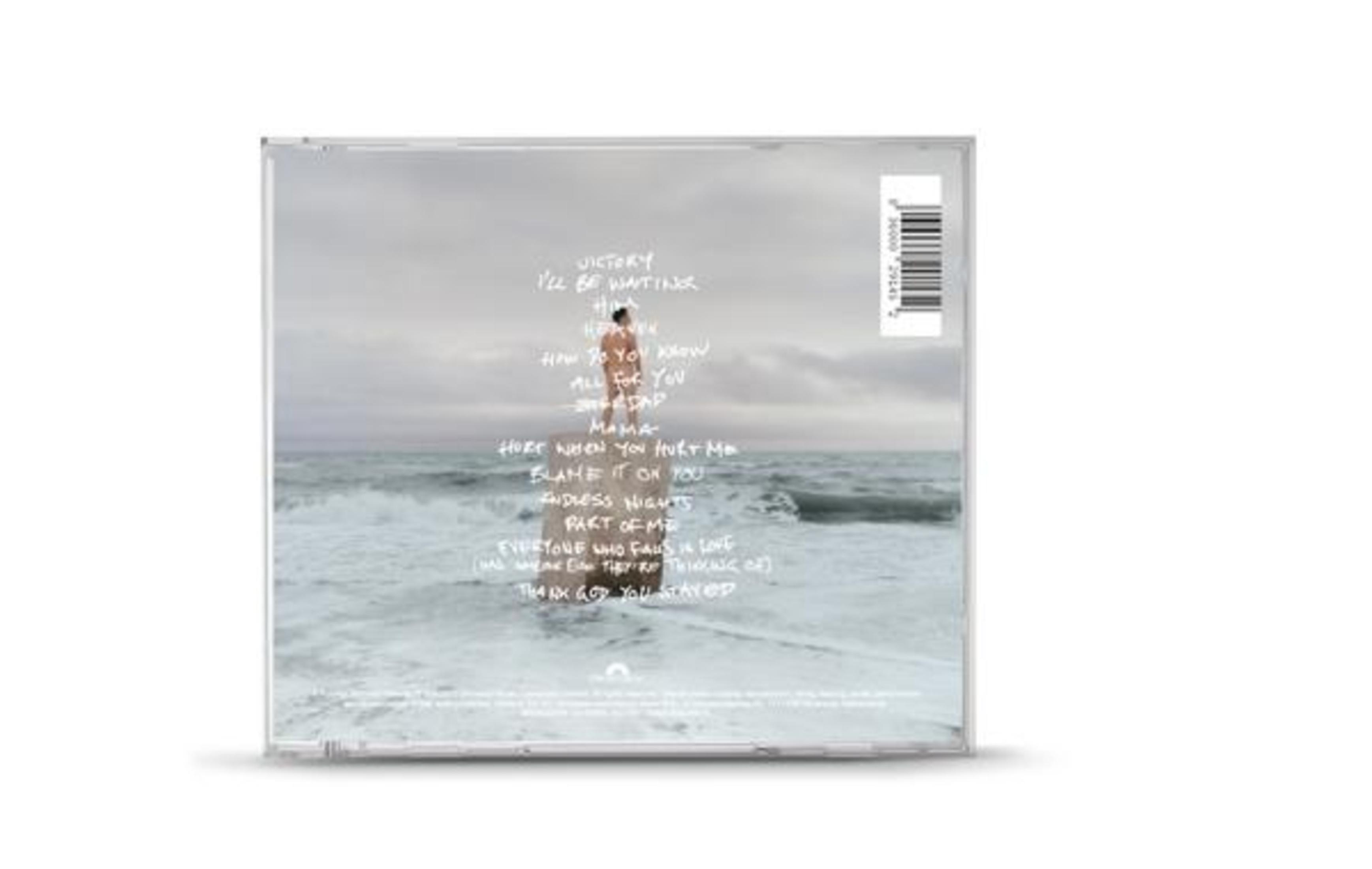 Album cover with a person standing on the beach. Lyrics are written on the back.