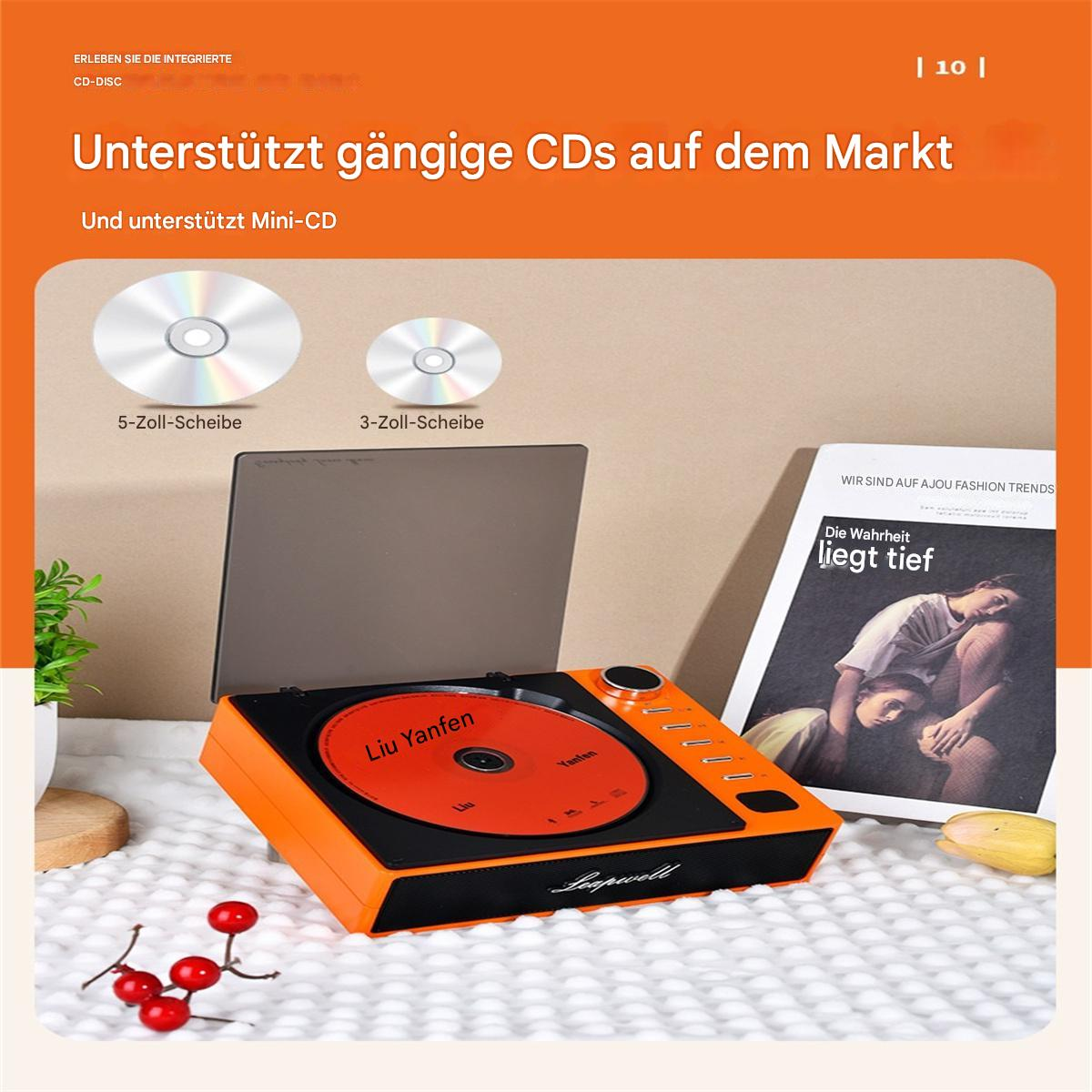 Oranger Plattenspieler mit eingelegter CD, unterstützt Mini-CD. Magazin und rote Beeren daneben.