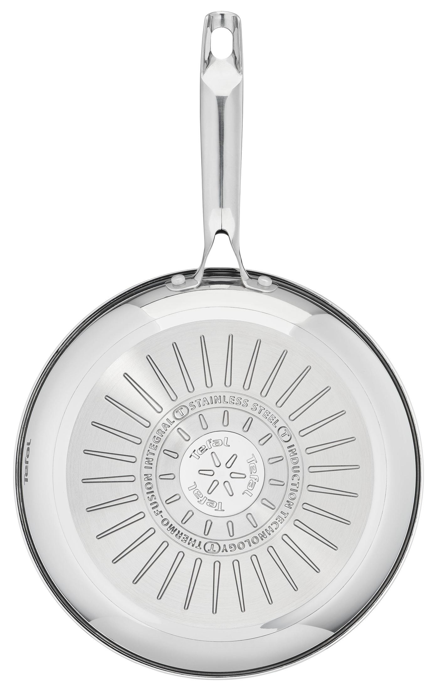 Stainless steel frying pan with a handle. Bottom of pan has a patterned design. White background.