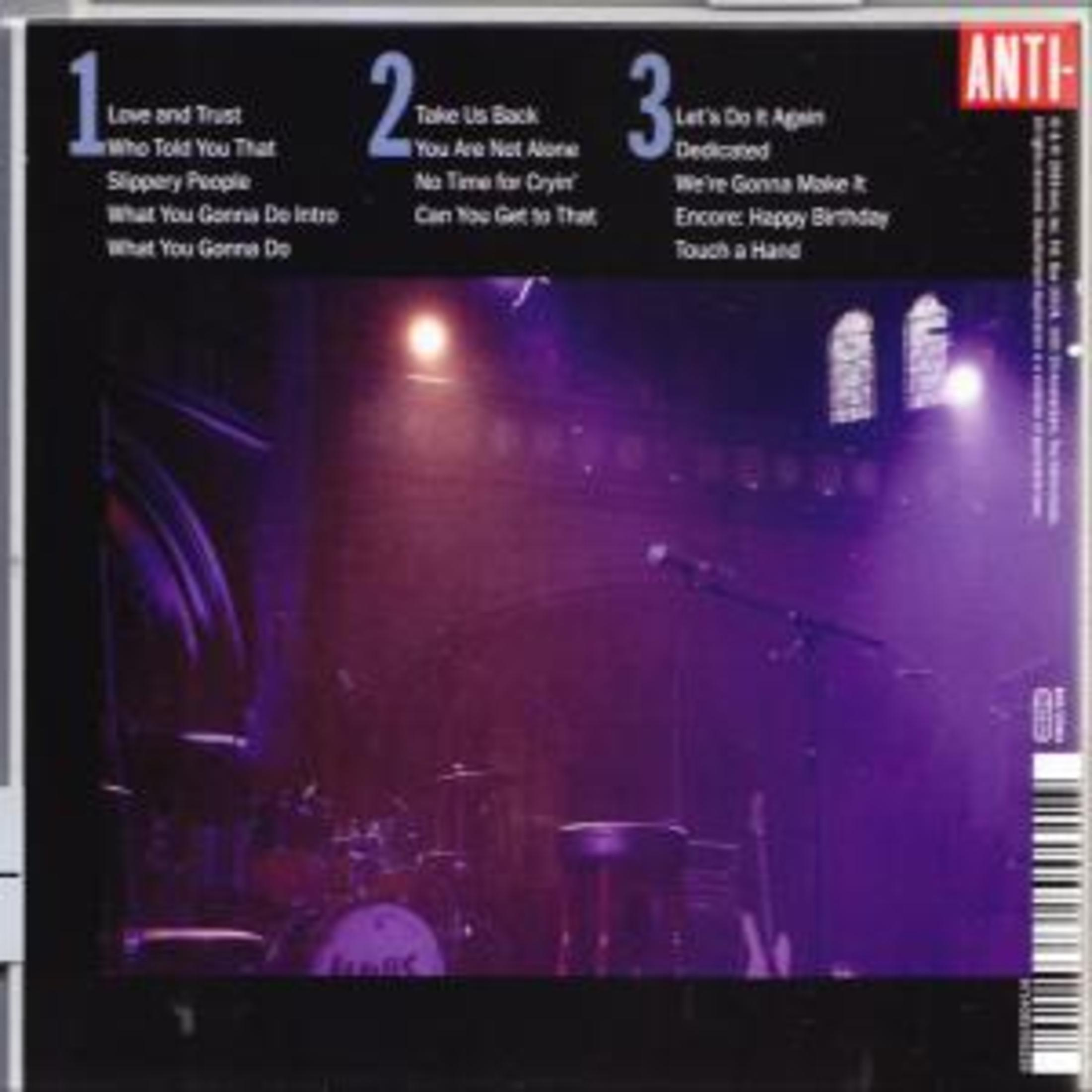 Album cover with stage and band instruments. Numbered song list on the left.