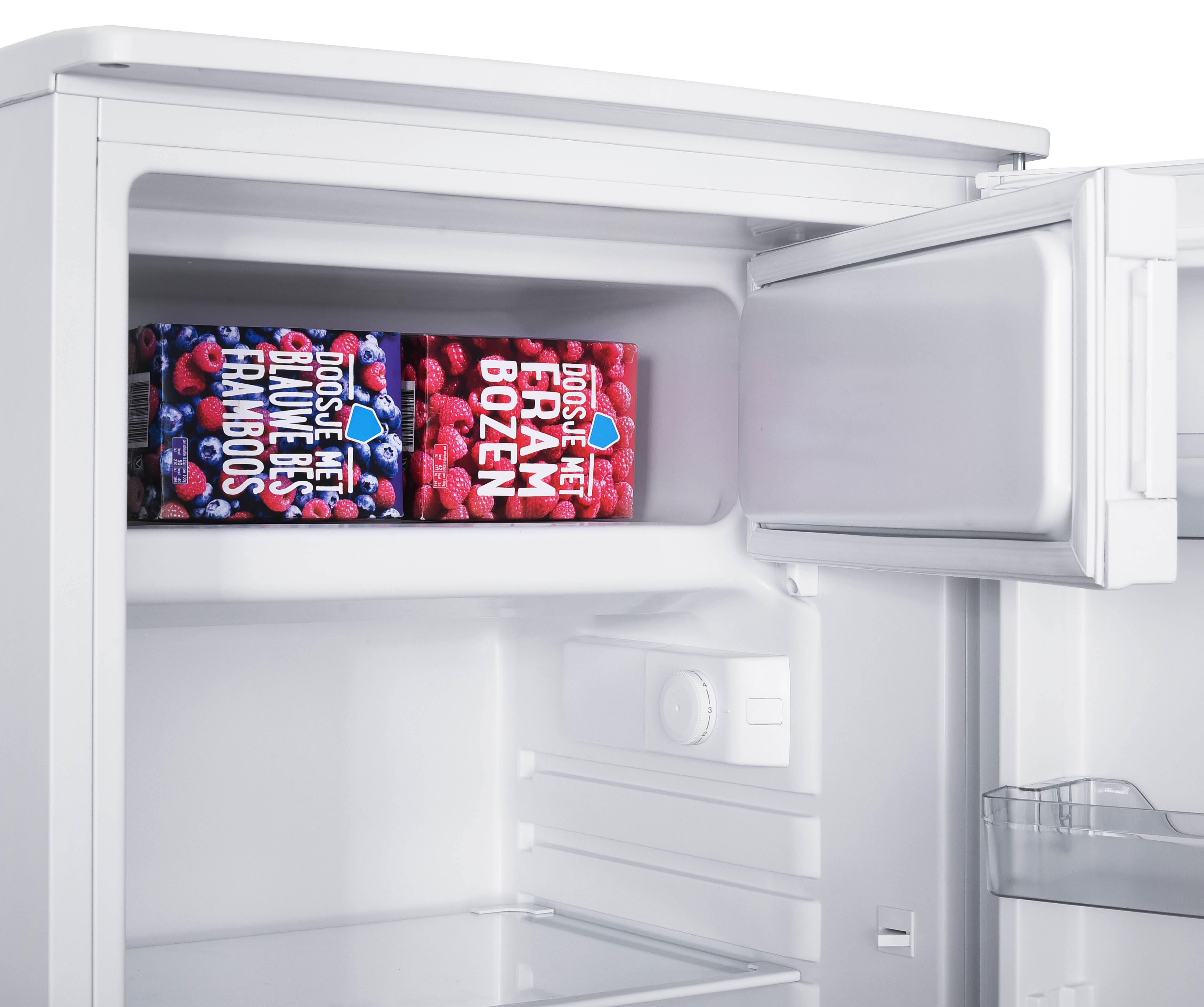 Inside of a white refrigerator with two boxes of berries.