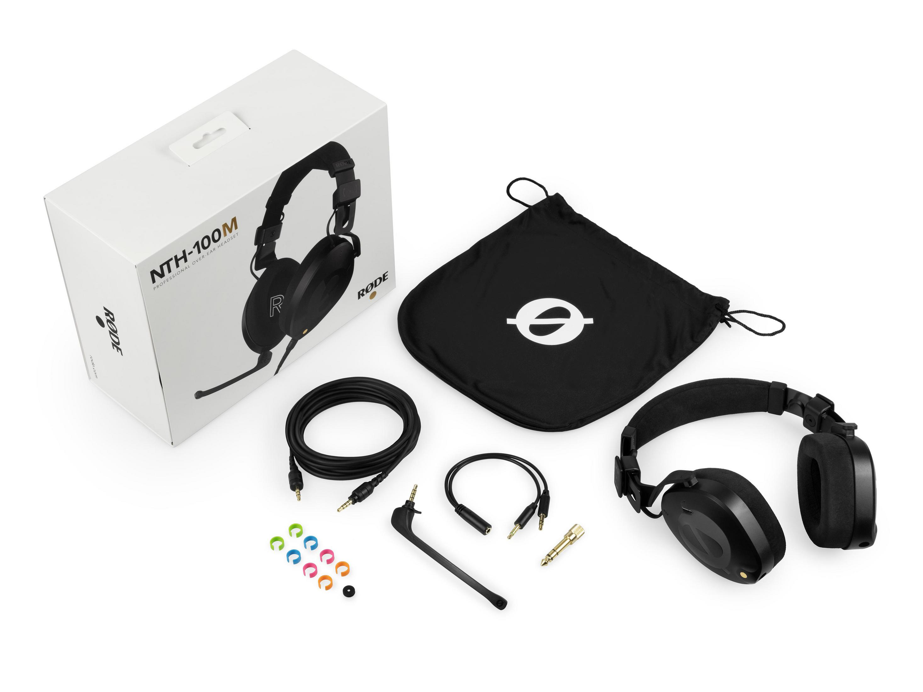 Słuchawki, pudełko i akcesoria na białej powierzchni. Czarne słuchawki widoczne.