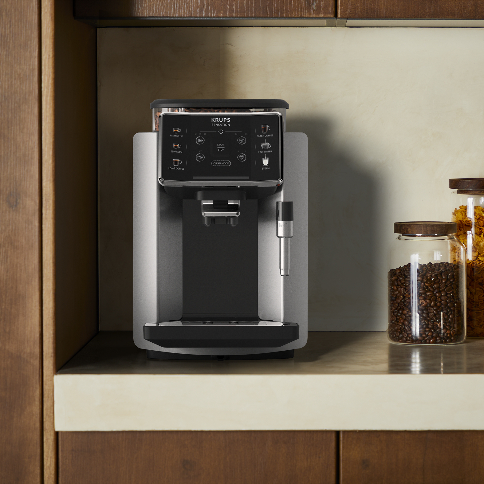 Srebrno-czarny ekspres do kawy Krups Sensoria na blacie. Widoczne elementy sterowania i pojemniki na ziarna.
