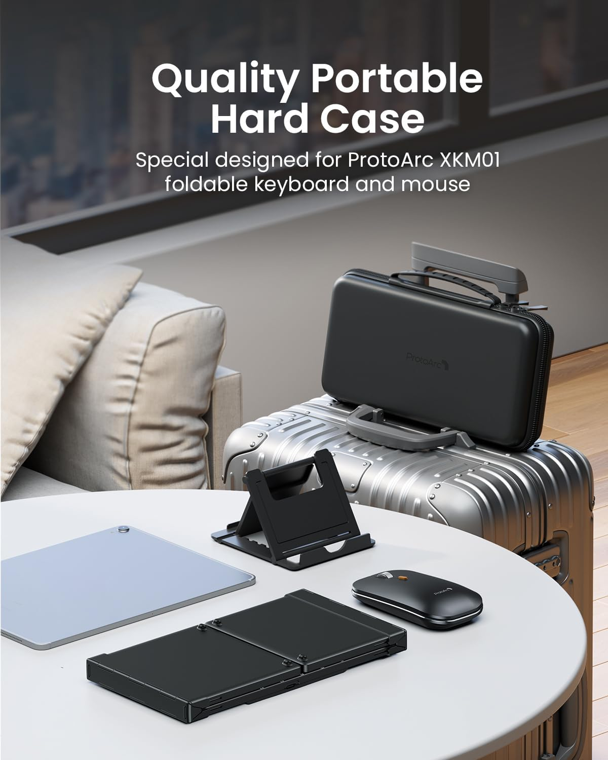 Black keyboard, mouse, and case are on a table. A suitcase and tablet are in the background.