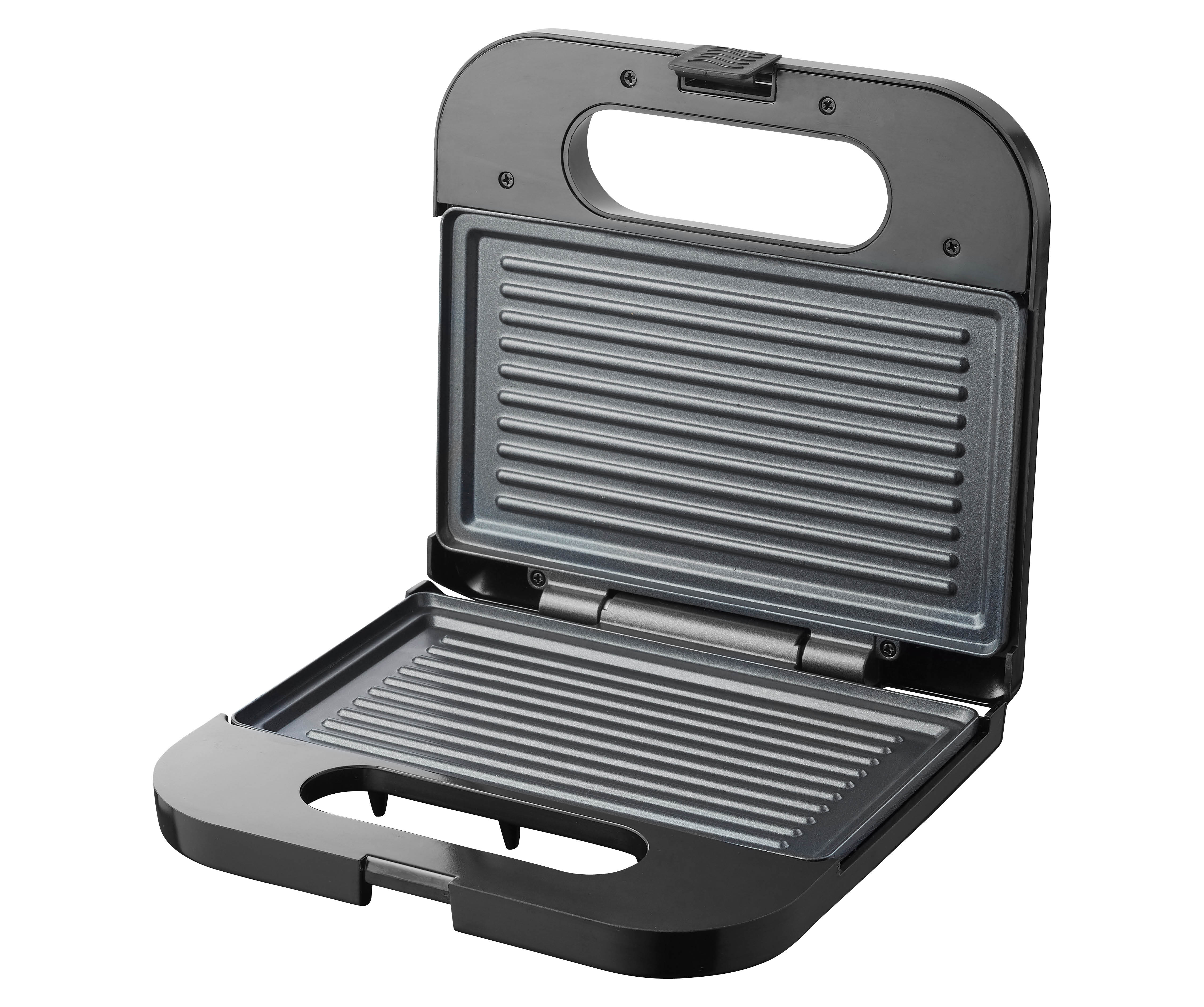 An open black sandwich maker with a ridged surface inside.