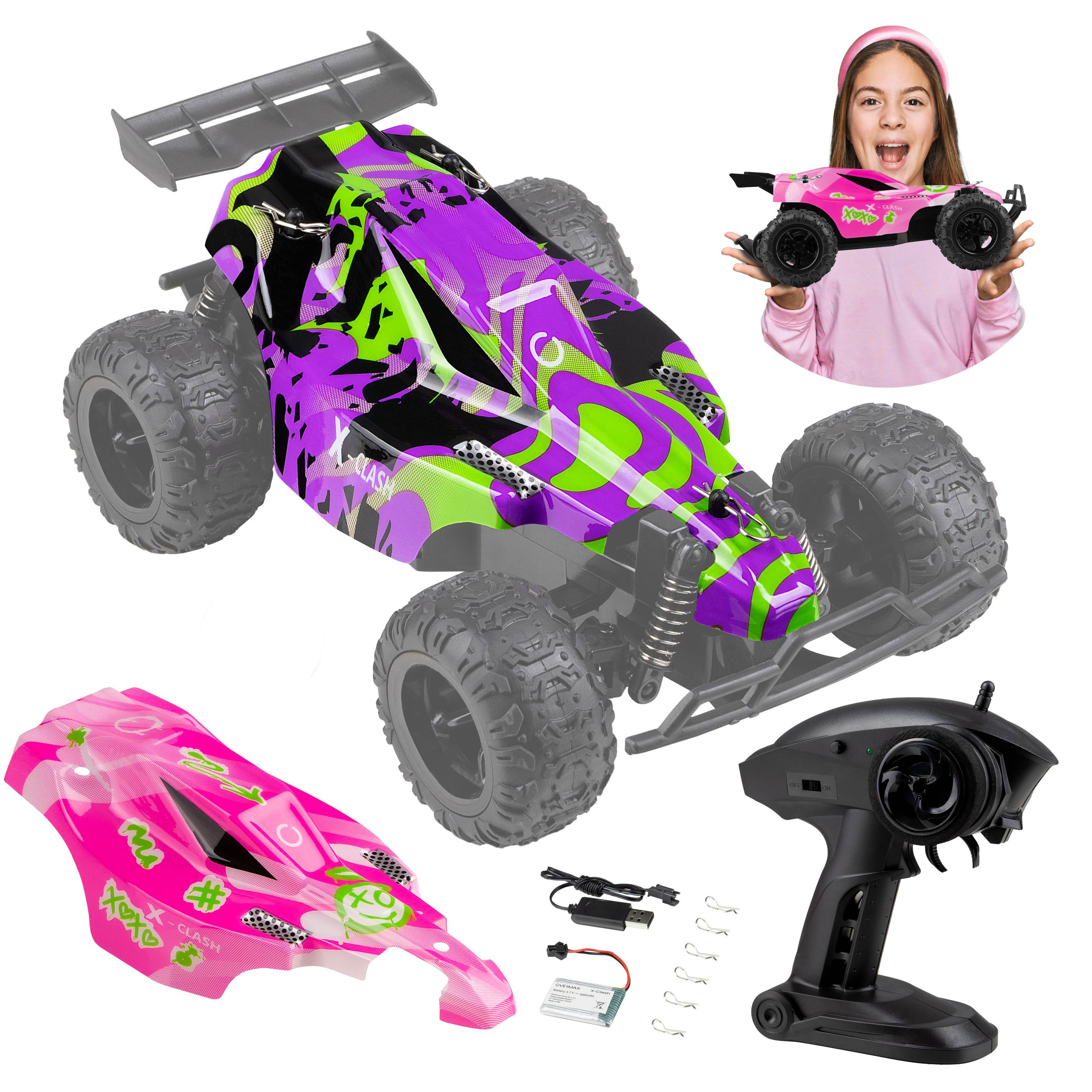 A girl holds a small pink toy car, next to a bigger one and other toy car parts. White background.