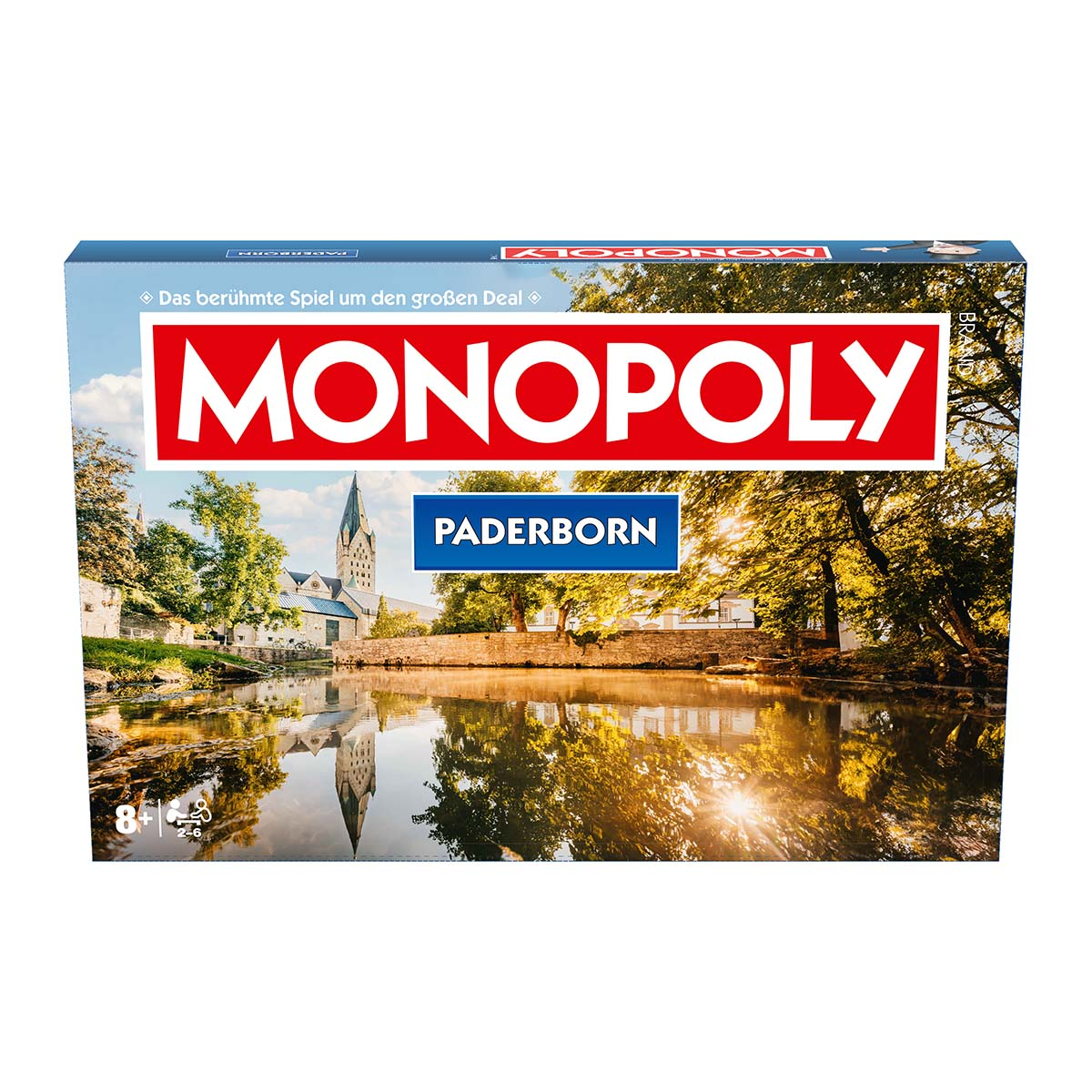 Monopoly-Spielbox mit einer Stadtszene von Paderborn, Deutschland, mit Fluss und Kirche.