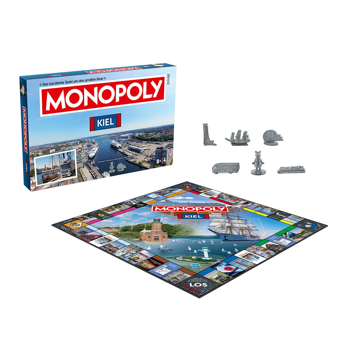 Monopoly-Brettspielbox und Spielbrett mit Metallspielsteinen auf weißem Hintergrund.